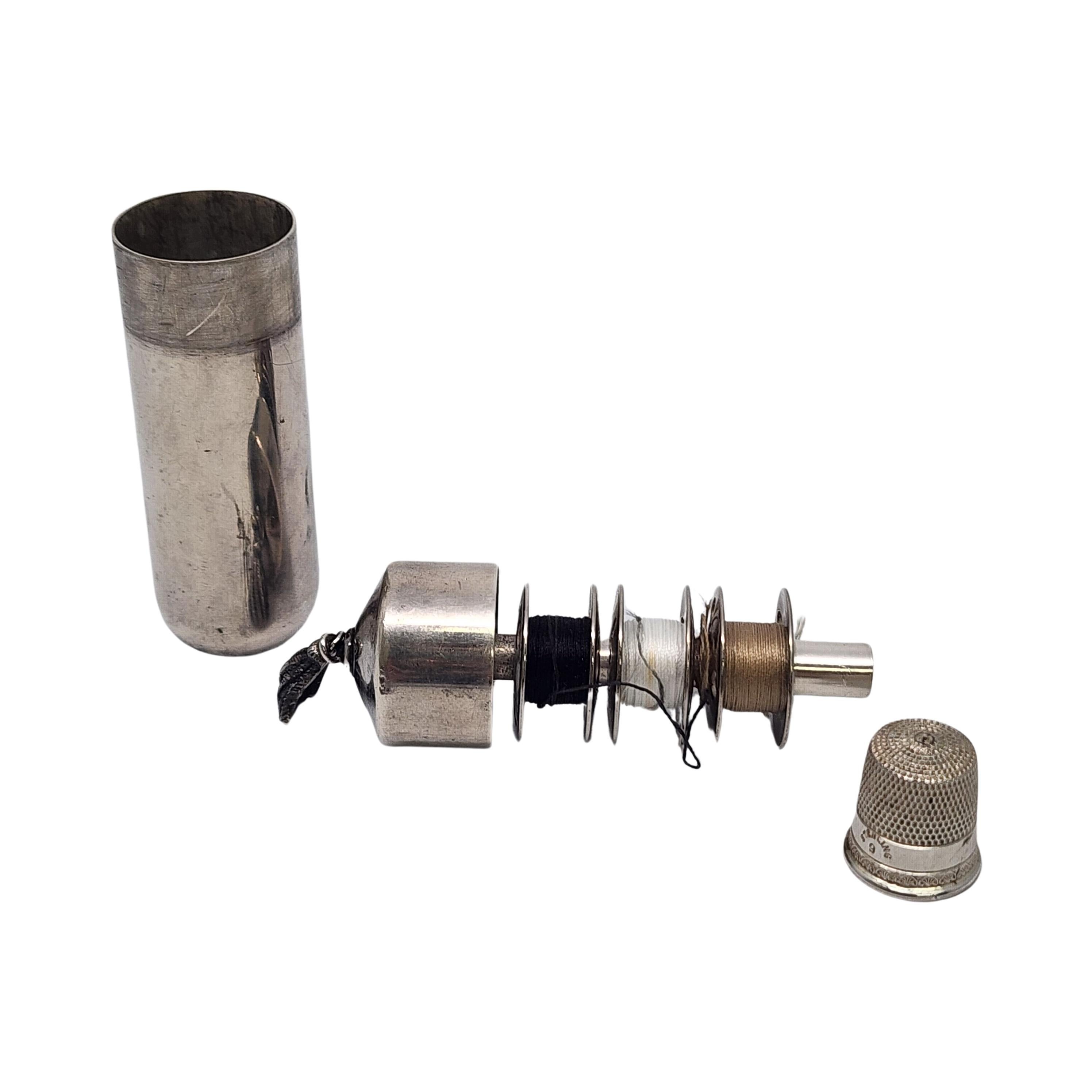 Sterling silver travel sewing kit with thimble and bobbins by Tiffany & Co.

No monogram.

Small cylindrical case carries a traveling sewing kit that hold needles, a thimble and bobbins of thread. Hallmarks date this piece to manufacture under the