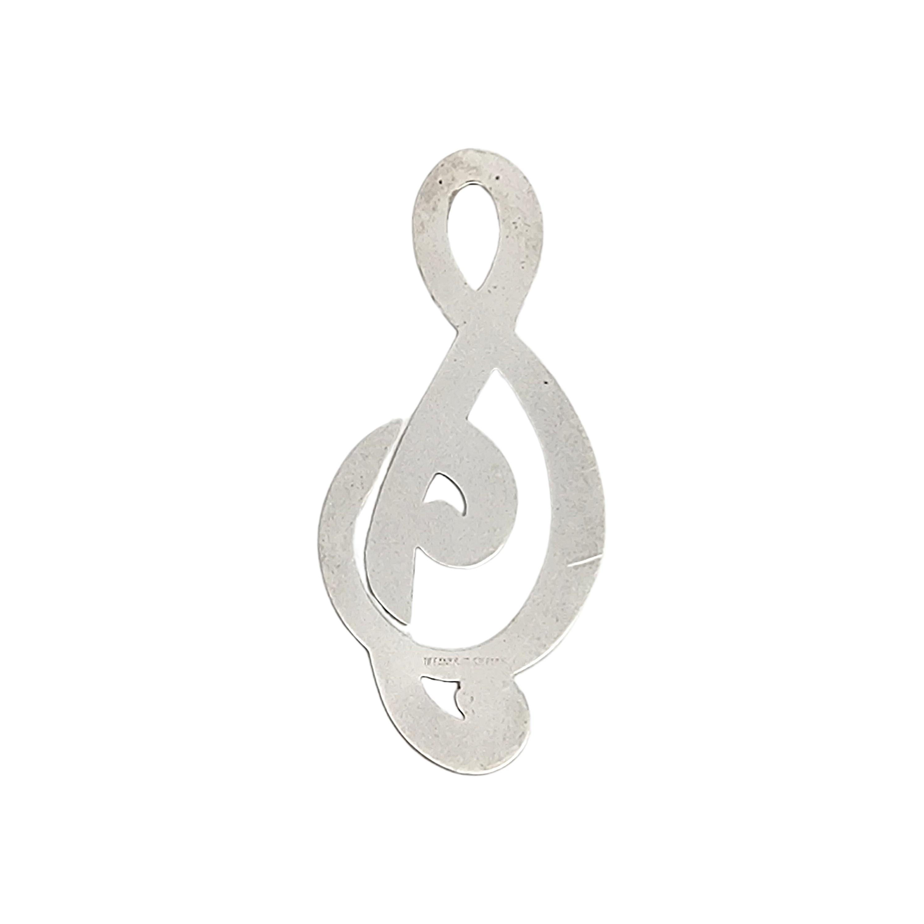 Tiffany & Co sterling silver treble clef bookmark clip.

Authentic Tiffany sterling silver bookmark or clip in the shape of a musical treble clef. Does not include Tiffany & Co box or pouch.

Measures approx 3