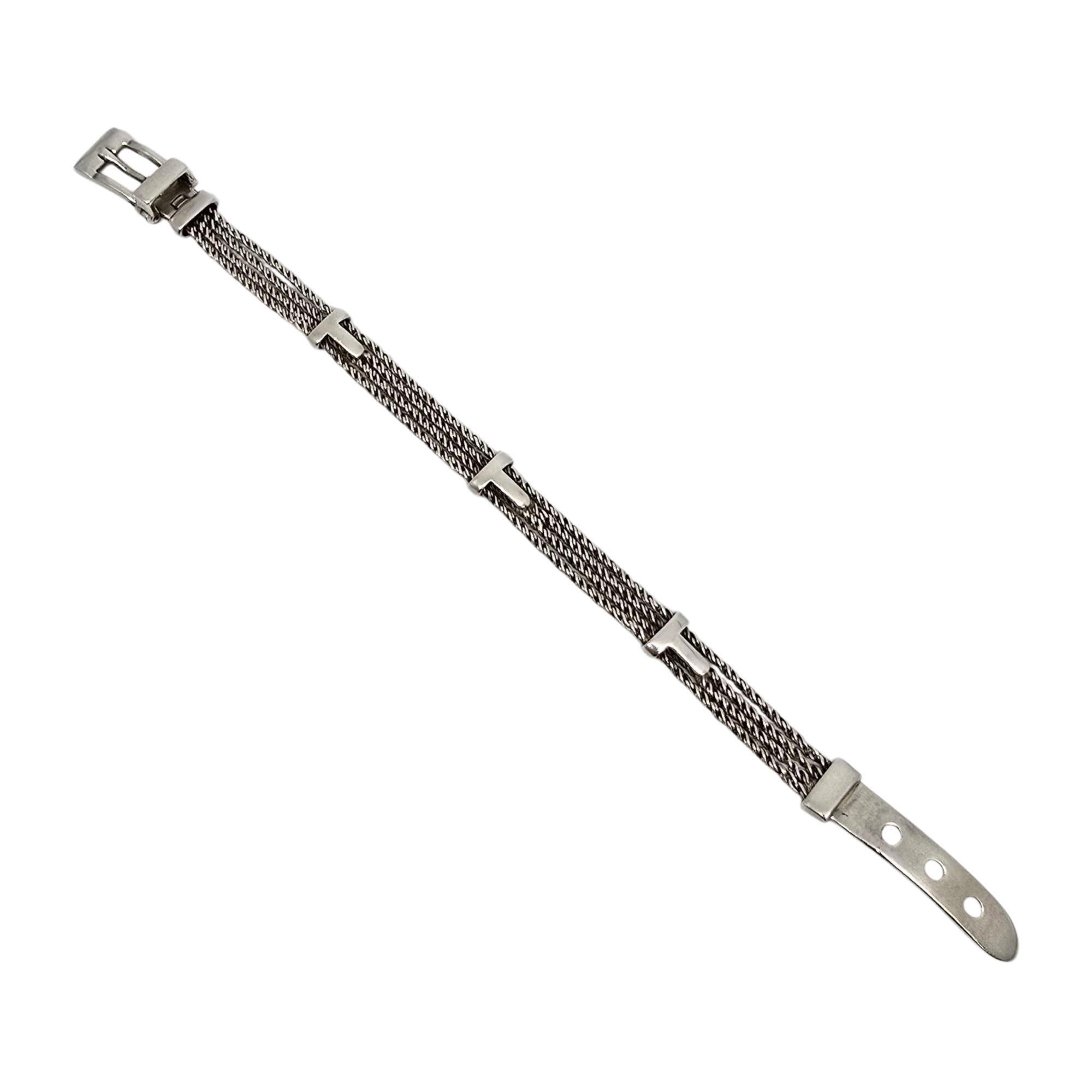 Sterling silver twist rope belt buckle bracelet with T accents by Tiffany & Co.

This Tiffany & Co bracelet features 3 twist ropes with T accents and a belt buckle closure. The clasp opens and closes to secure the end of the belt. Tiffany & Co box