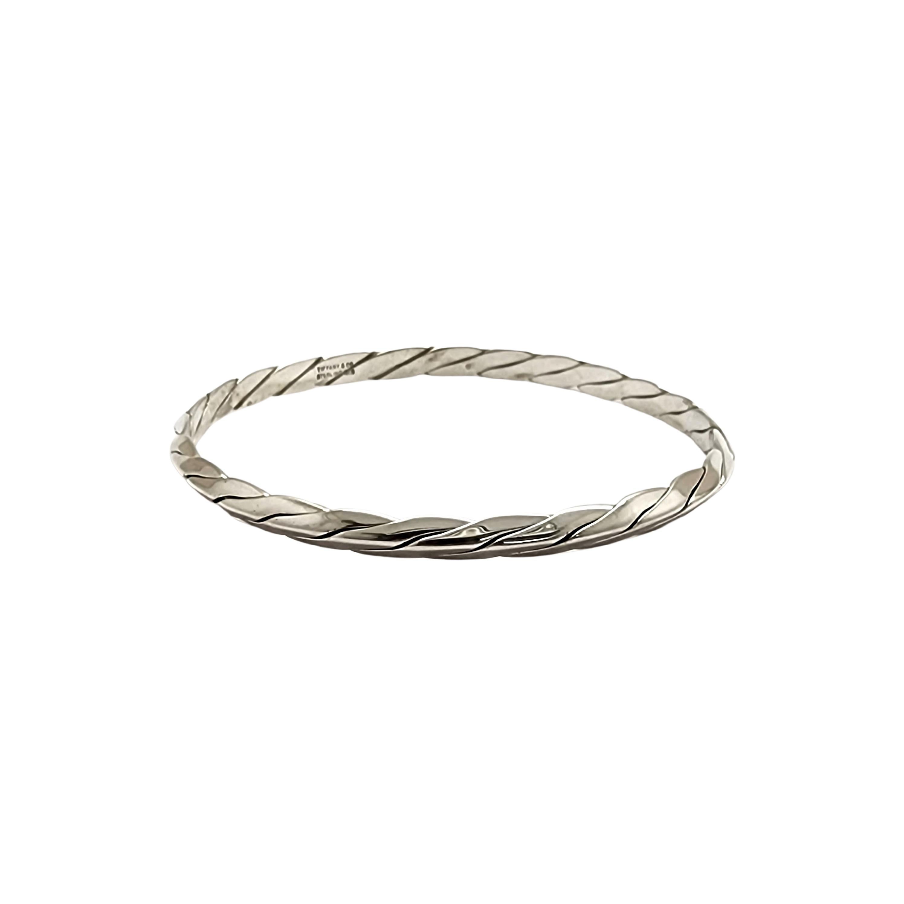 Tiffany & Co sterling silver twisted rope cable bangle bracelet.

An authentic Tiffany & Co bracelet featuring a twisted rope knife edge design. Tiffany box and pouch are not included.

Measures approx 7 3/4
