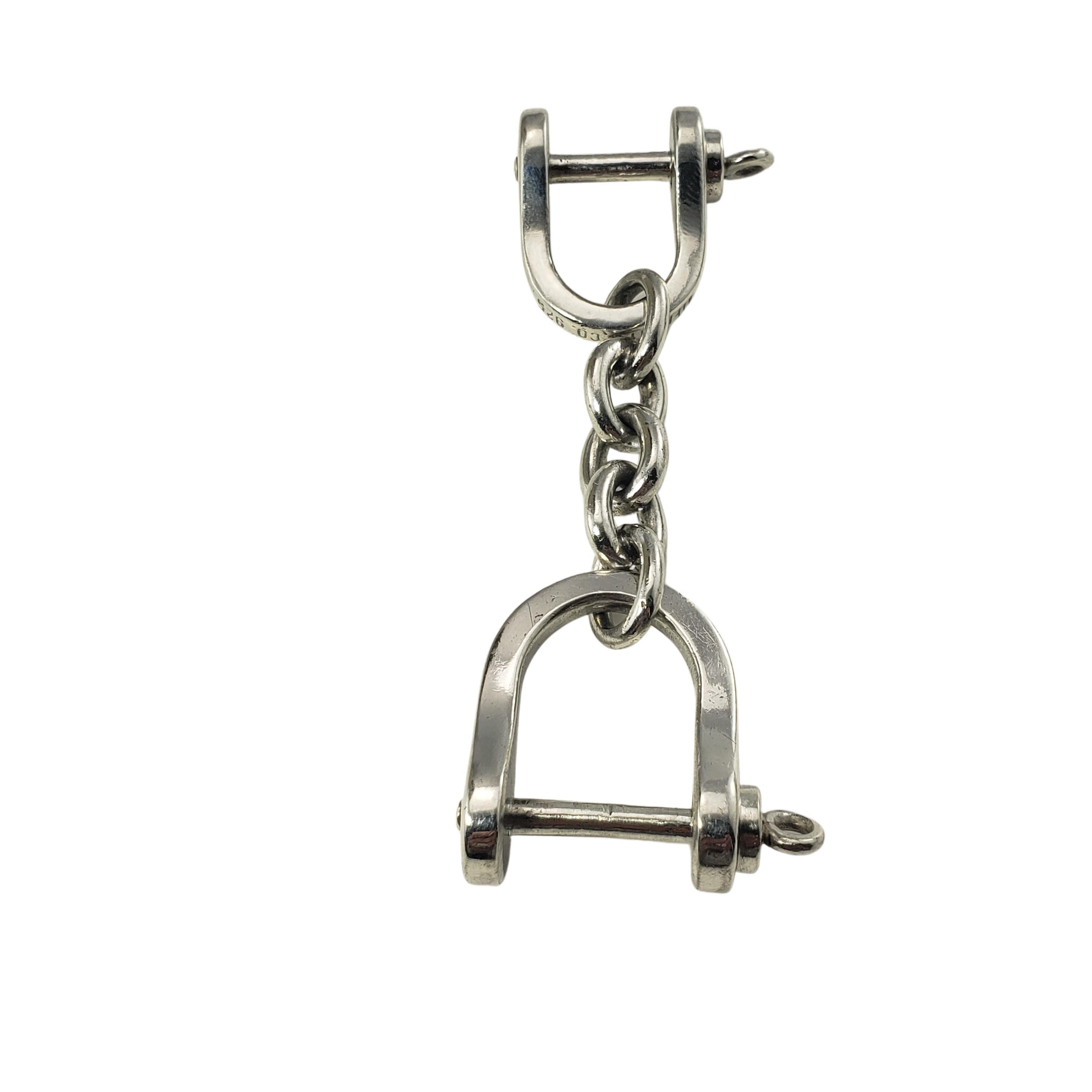 Tiffany & Co. Sterling Silver Valet Shackle Horsebit Keychain-

This elegant horsebit keychain with detachable valet link by Tiffany & Co. is crafted in meticulously detailed sterling silver.  

Size:  3.25 inches

Weight:    21.3 dwt. /   33.2