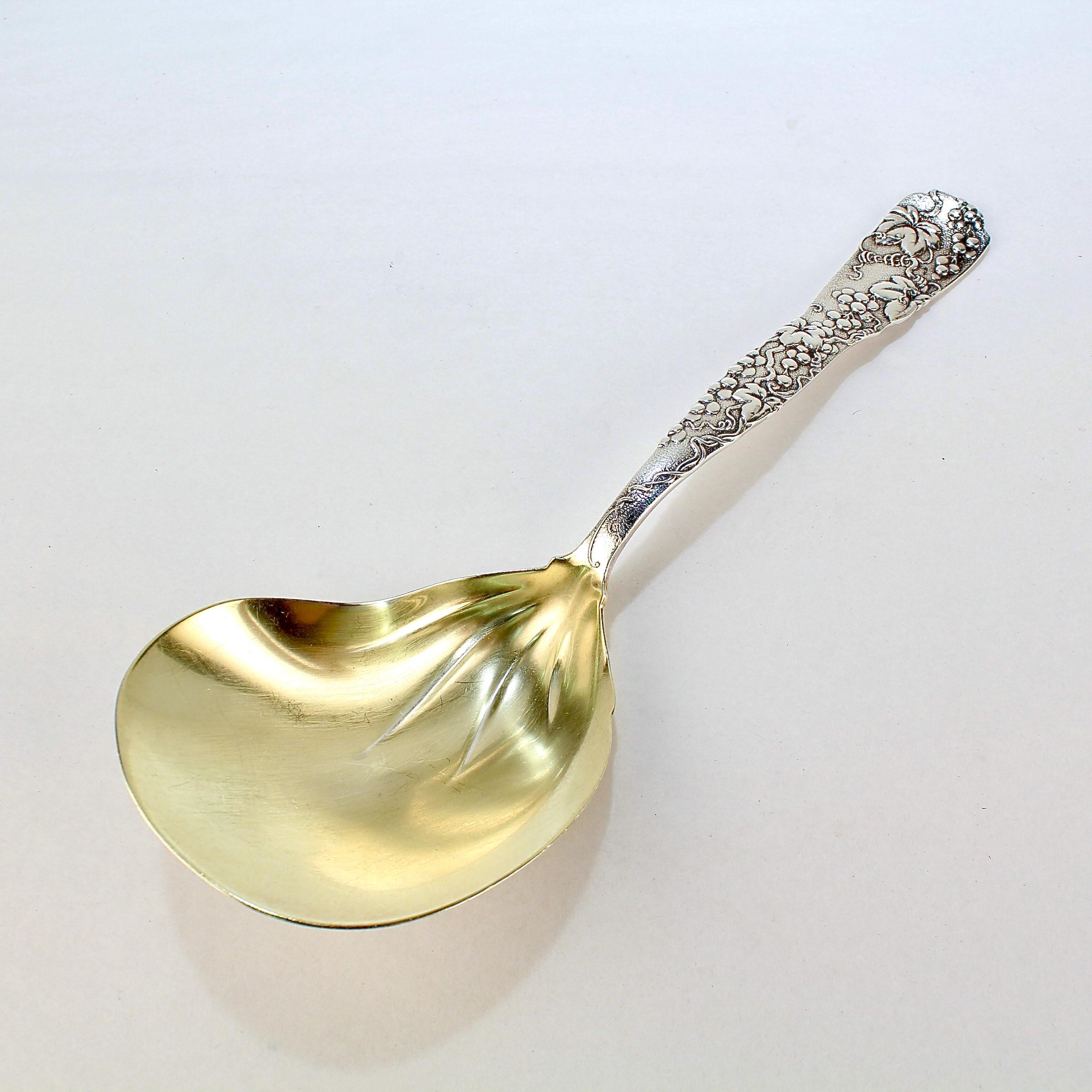 A very fine Tiffany & Co. sterling silver serving or berry spoon.

With a gold wash to the bowl.

In the 'Vine' pattern with a conch shell shaped bowl and an embossed grape vine decorating the length of the handle. 

Simply a great Tiffany serving