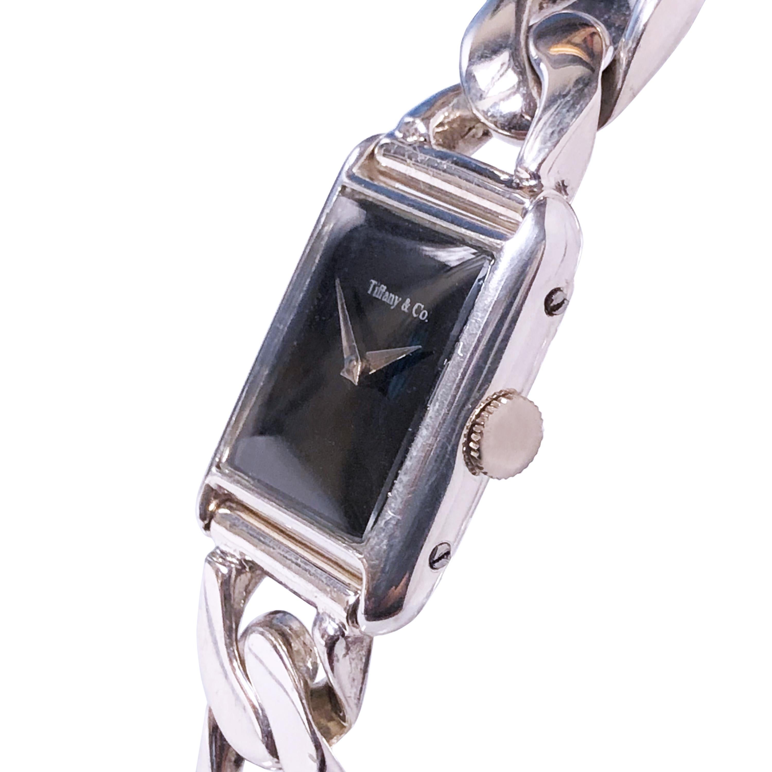 Circa 1980 Tiffany & Company Bracelet Wrist Watch. 27 X 20 MM Sterling Silver 2 piece Case. Mechanical, Manual Wind Movement. Black Dial. 1/2 inch wide Sterling Silver Bracelet, case back stamped 