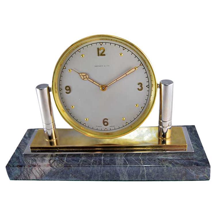 FACTORY / HOUSE: Tiffany & Co.
STYLE / REFERENCE: Art Deco / Articulated Desk Clock 
METAL / MATERIAL: Nickel, Brass, Stone
CIRCA / YEAR: 1930's
DIMENSIONS / SIZE: 12 Length X 17 Diameter
MOVEMENT / CALIBER: Manual Winding / 15 Jewels / 8 Days
DIAL