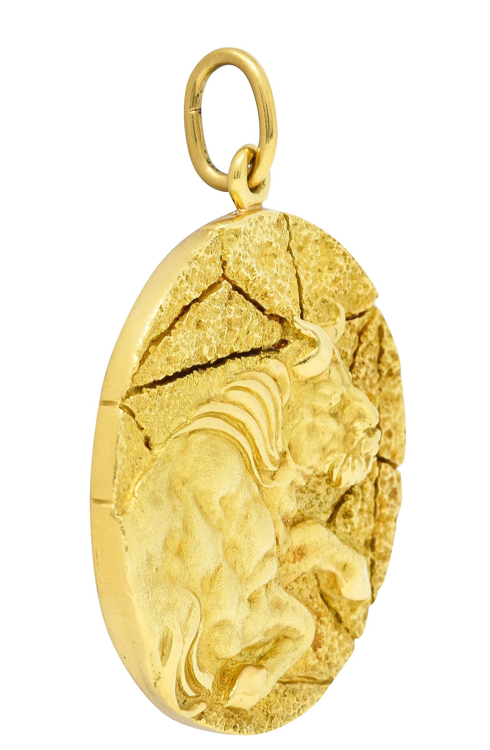 Substantial circular pendant is designed with a textured cracked earth motif

Depicting a highly rendered image of a rearing bull with high polished accents

Back features a stylized Taurus zodiac sign - brightly polished

Stamped K18 for 18 karat