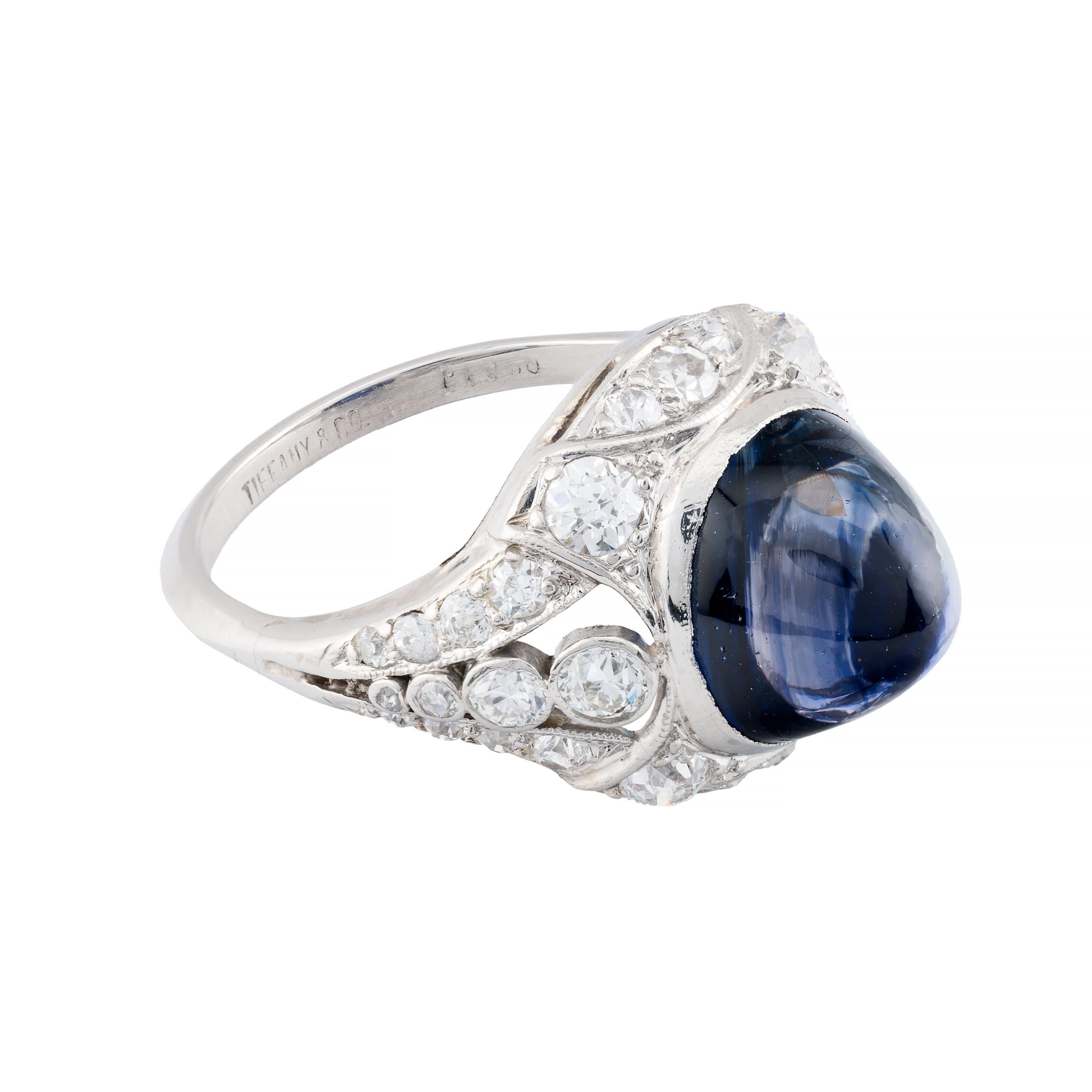 Aston Estate Jewelry Presents:

A striking Tiffany & Co Art Deco statement ring from 1920. Crafted in platinum, this piece features a captivating 6.20 carat sugarloaf cabochon sapphire, showcasing a deep blue hue. Certified by the GIA, the sapphire