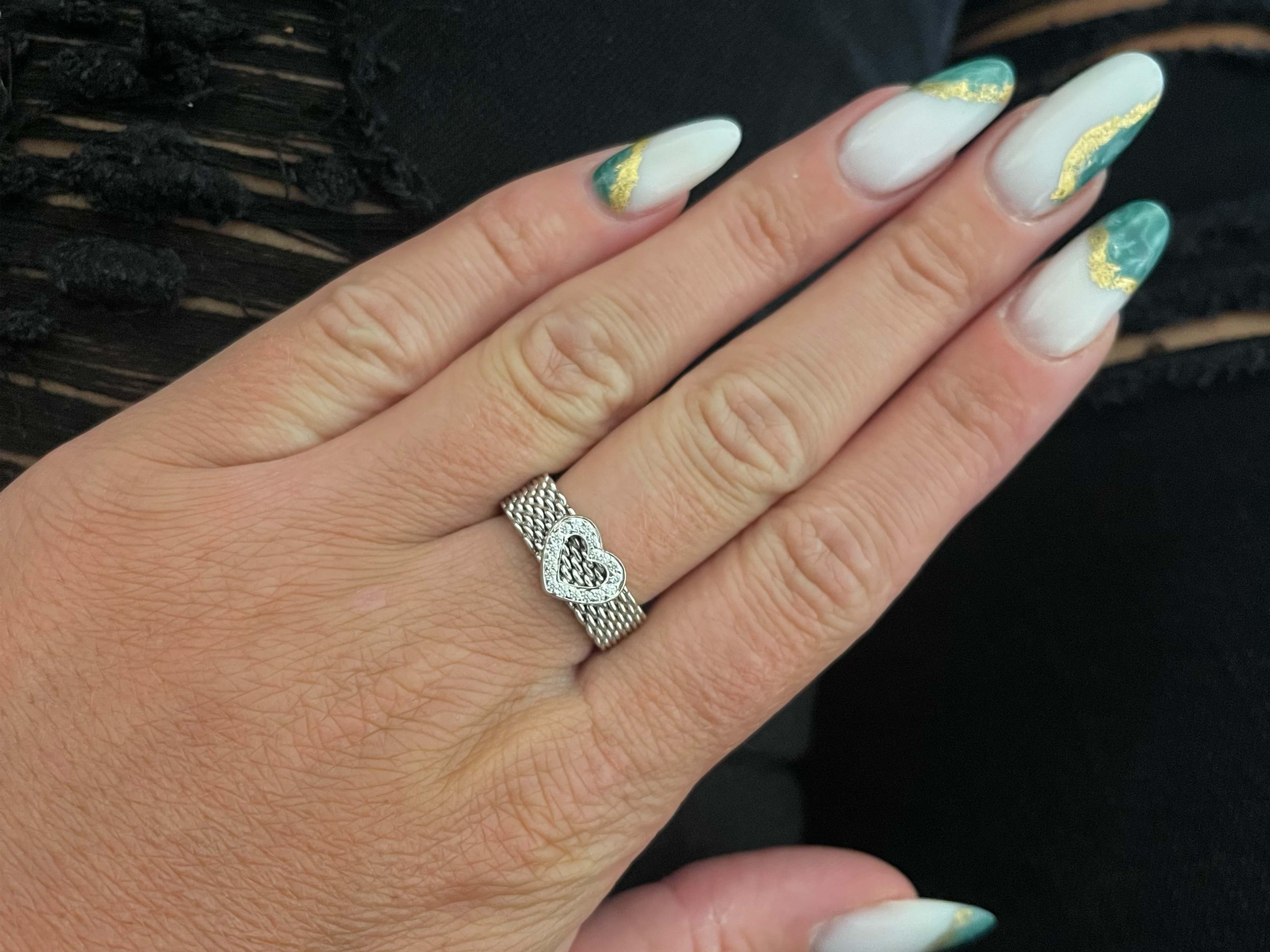 Authentic Tiffany & Co. Summerset Diamond Heart Ring in 18k White Gold. This diamond heart mesh ring is beautifully crafted in 18k white gold with 18 diamonds on the heart. The diamonds are F-G in color and VS in clarity and total ~0.10 carats. The