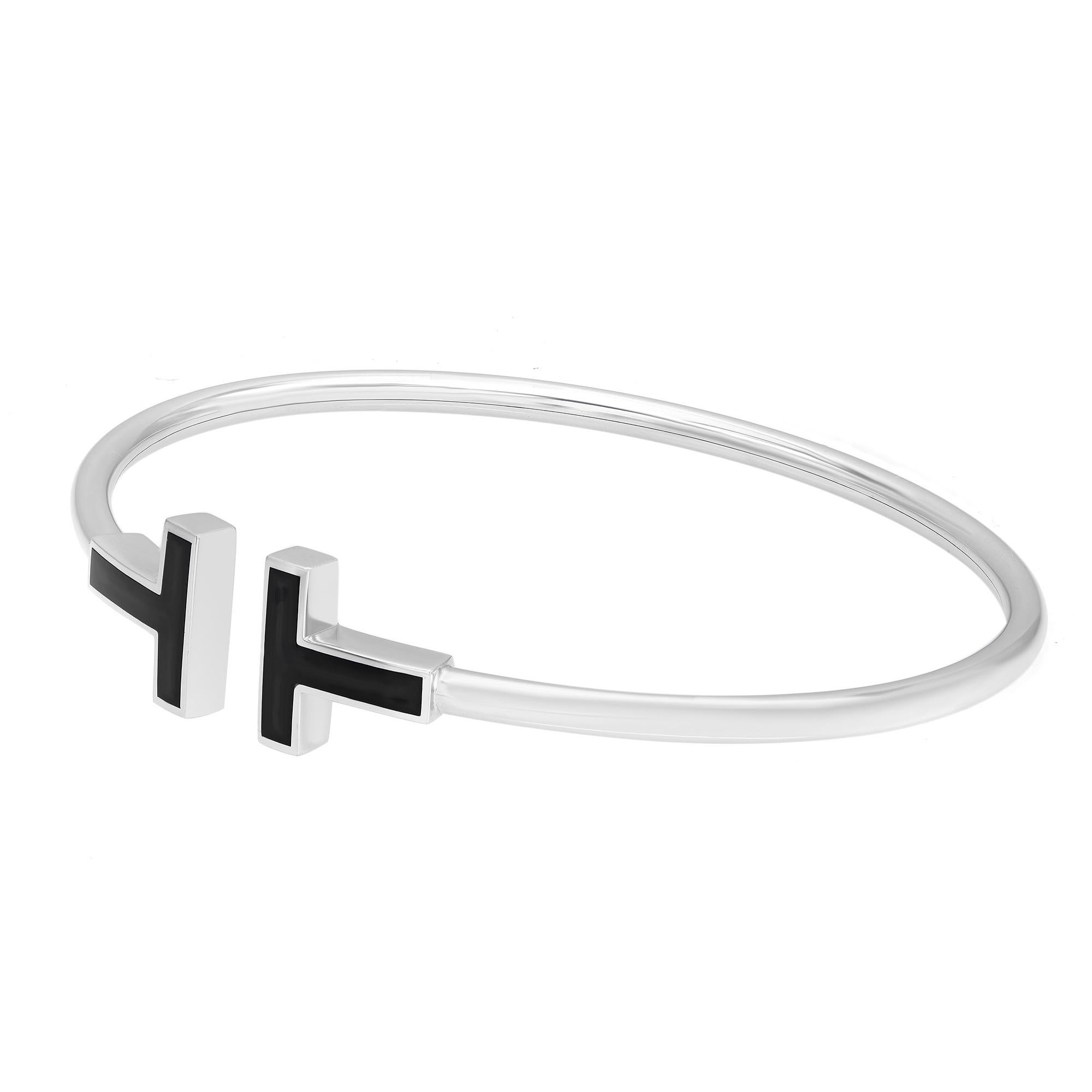 The Tiffany T collection showcases this modern wire bracelet, enhanced with black onyx creating a bold design with a smooth finish and high polish. Crafted in 18k white gold. Size Small. Fits wrists up to 5.75. Total weight: 8 grams. Wear this sleek