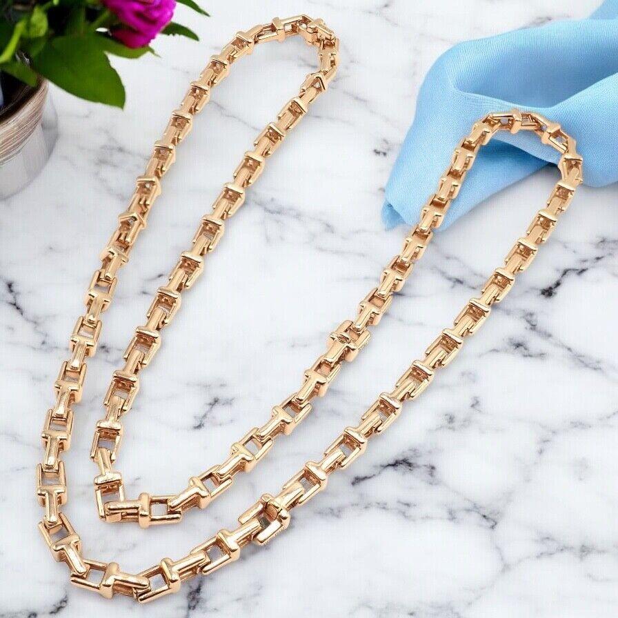 18k Rose Gold T Chain Link Long Chain Necklace by Tiffany Co.
Experience refined luxury with Tiffany & Co’s 18k Rose Gold T Chain Link Long Necklace, measuring 20.5 inches. 
Its interlocking T motifs form a graceful silhouette, exuding timeless