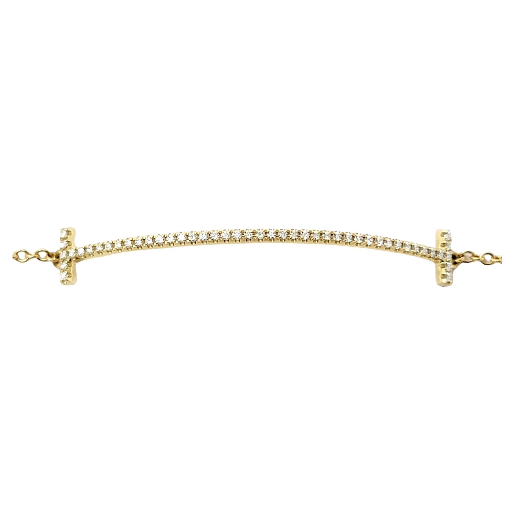 See minimalist elegance at its finest in this gorgeous Tiffany T Smile bracelet.  Sparkling Tiffany diamonds trace the elegant curve of this stunning piece, enhancing the clean lines and contemporary design. Pair it with other bracelets for a