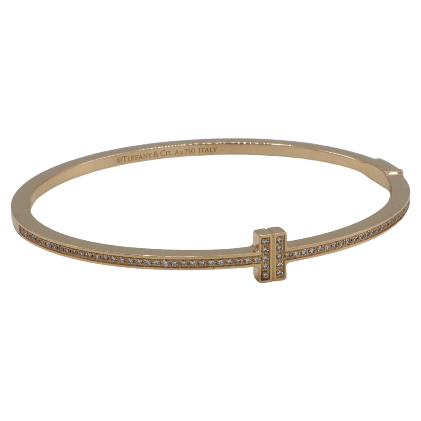 Tiffany & Co. T Diamond Hinged Wire Bangle in 18k Rose Gold
Metal: 18k rose gold
Weight: 16.5 grams
Diamonds: Approx. Carat total weight .33 G VS round diamonds
Size: Medium 6.5
