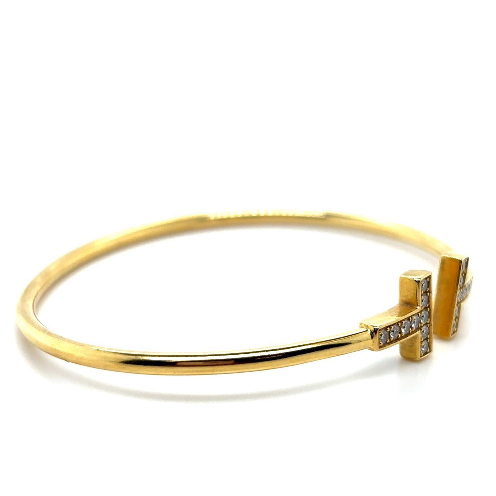 Bracciale a filo con diamanti AT&T in oro giallo 18 carati di Tiffany & Co.

Questo bracciale dell'attuale collezione Tiffany & Co. è un bracciale in oro giallo a filo spesso e lucido, rifinito con un paio di terminazioni a 