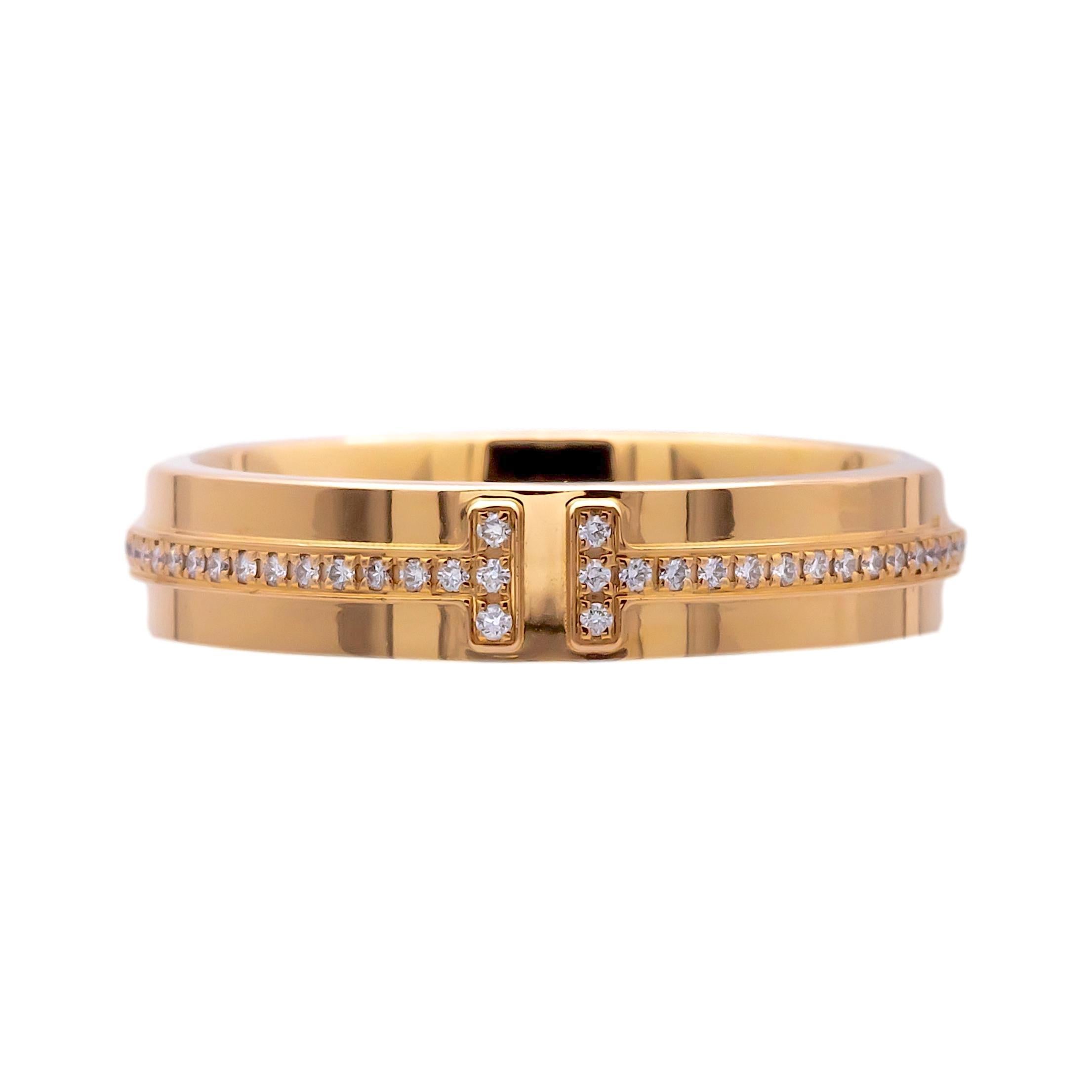 Tiffany & Co. wide band ring from the T collection. Crafted with meticulous precision in 18-karat rose gold, this masterpiece showcases a mesmerizing overlapping T motif thin band adorned with brilliant round cut diamonds, totaling 0.13 carats. With