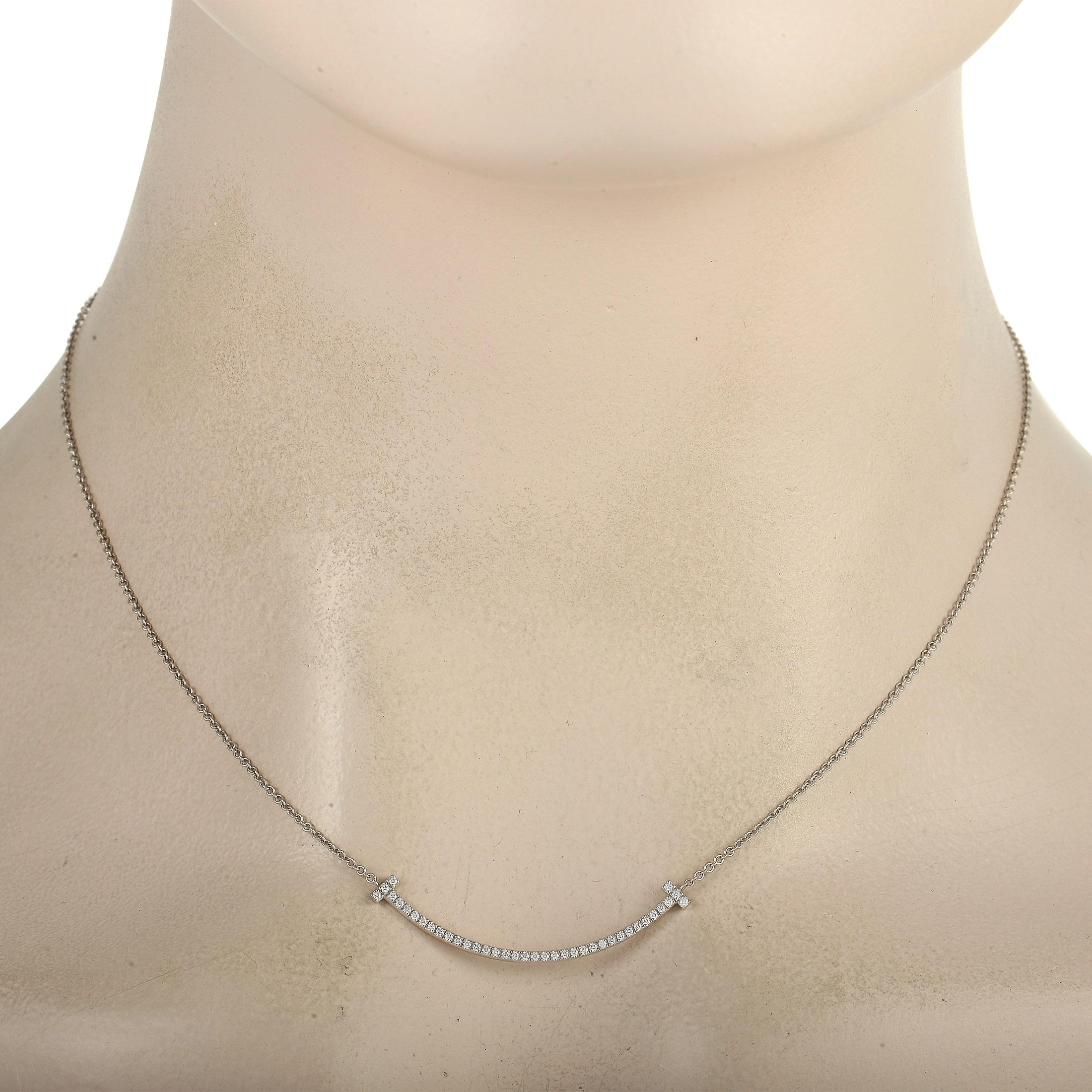 This pretty Tiffany & Co T Smile 18K White Gold Diamond Necklace is sure to brighten your day! The necklace features a fine 18K white gold chain, highlighting the beautiful 18k White Gold diamond T Smile pendant which measures 1.50 inches in length