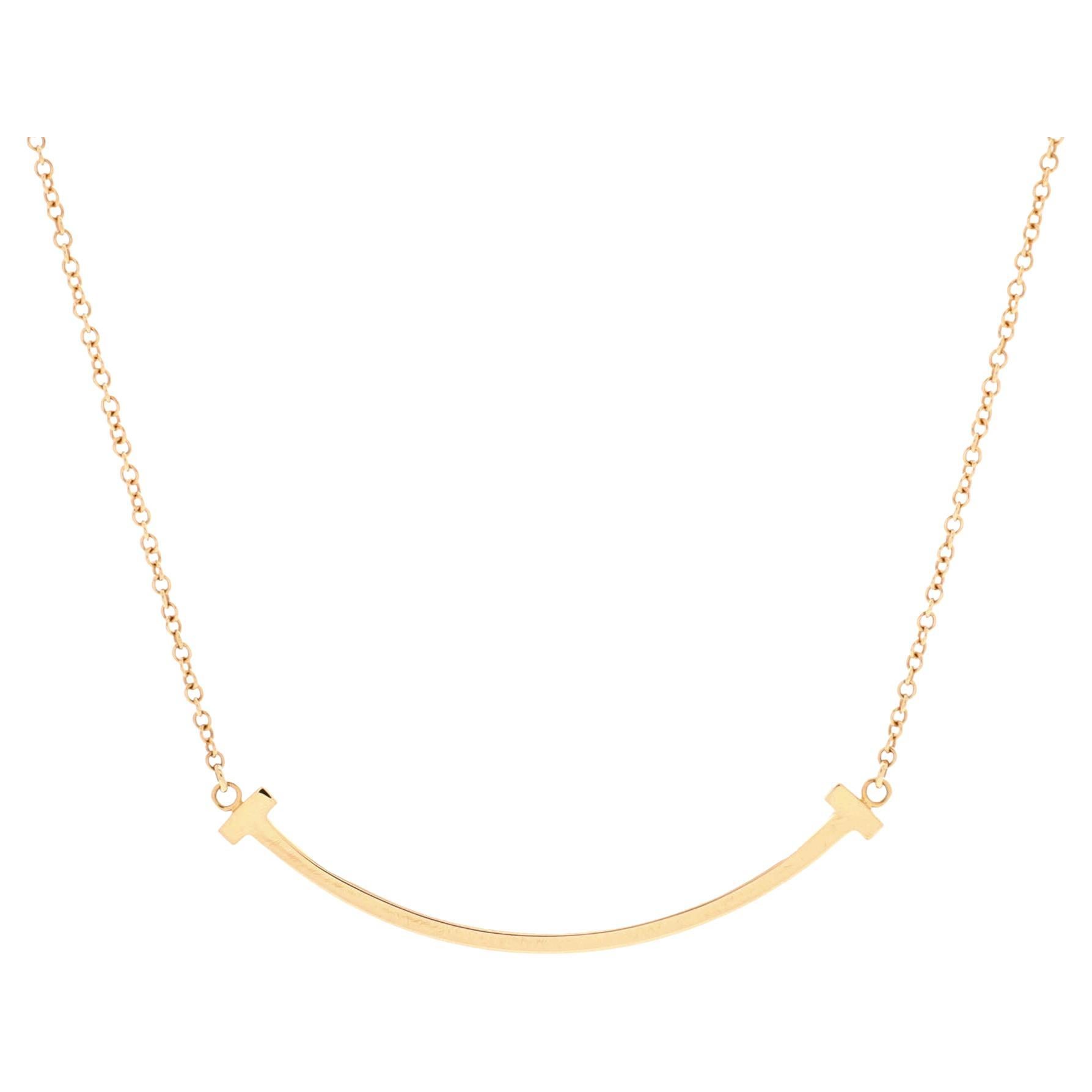 Tiffany T medium smile pendant in 18k gold with diamonds.
