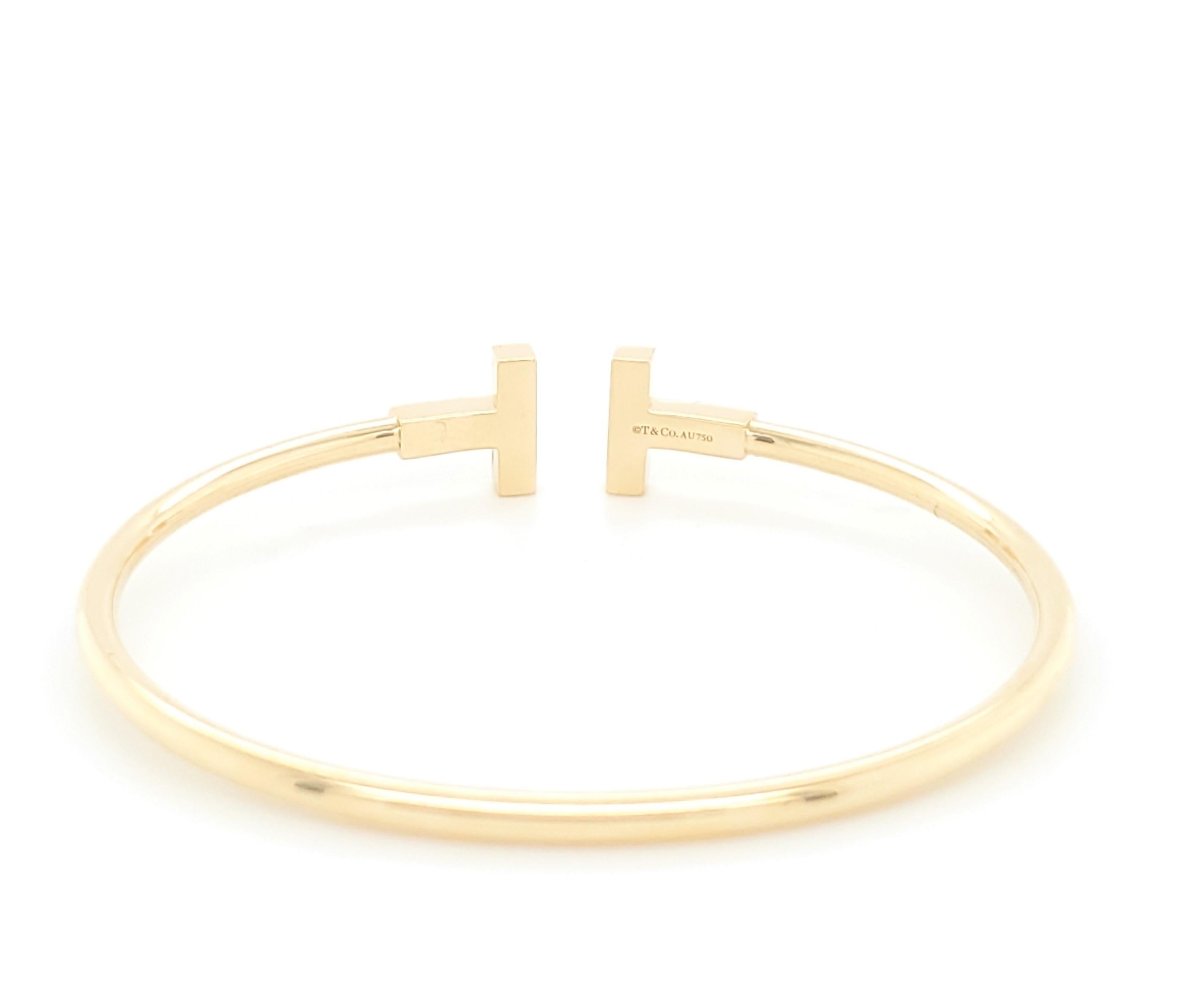 Authentic Tiffany & Co. T Square Wire bracelet made in 18 karat yellow gold with approximately 18 diamonds weighing an estimated .36 carats. Can fit up to a size 5 1/2 wrist.  Inspired by the strong, clean lines of the letter T, this bracelet is