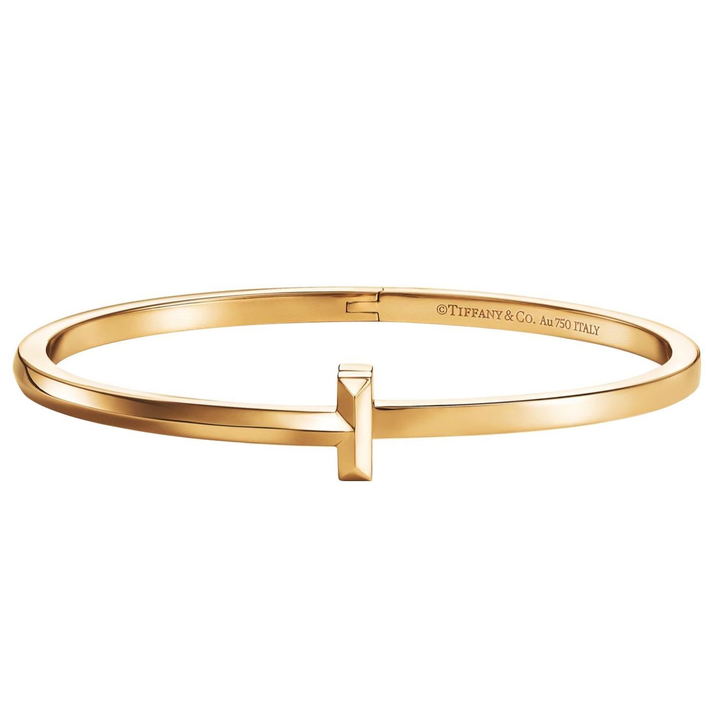 Wrapped around the wearer in a continuous, unbroken circle, this hinged bangle was expertly designed with a strong, beveled 