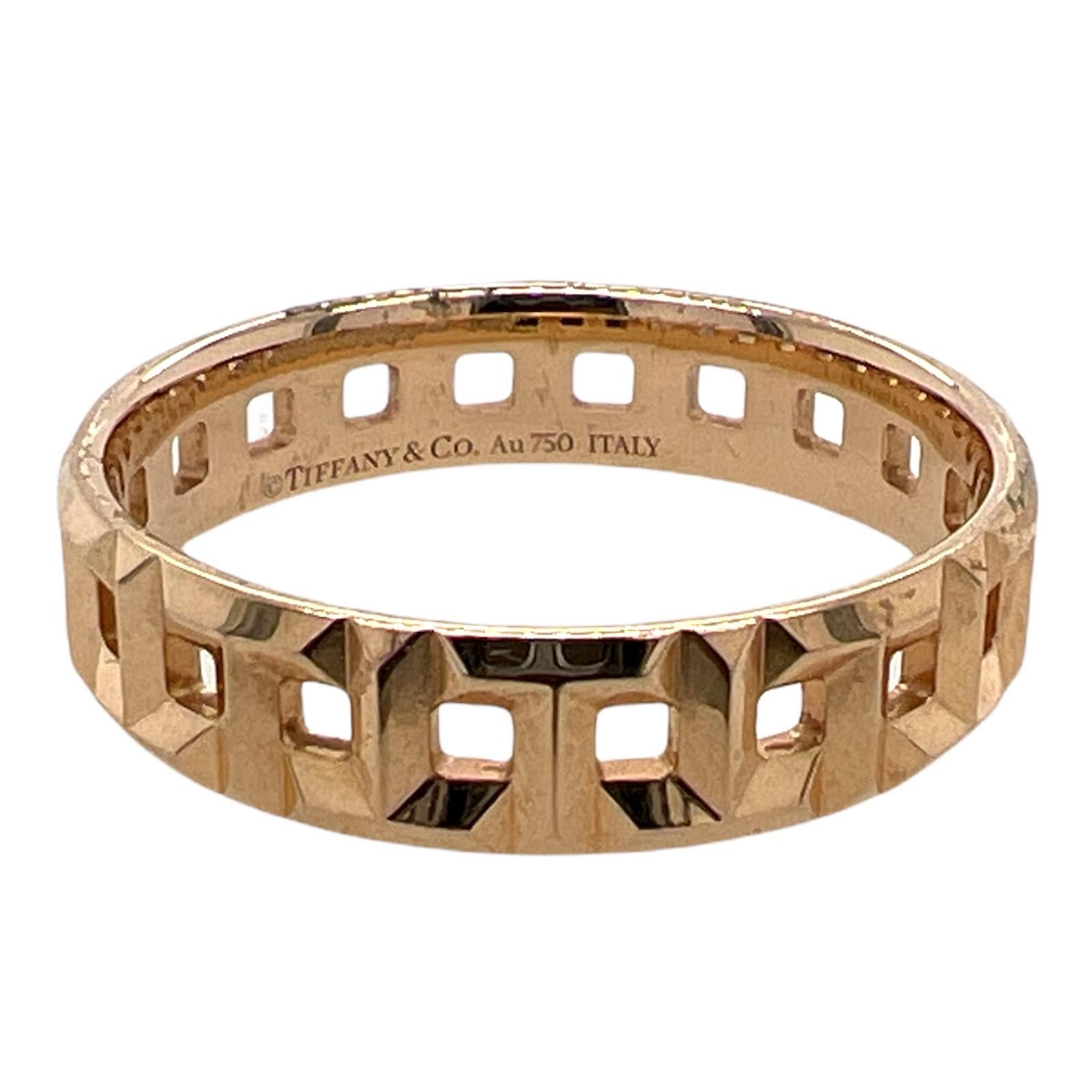 Men's Tiffany & Co. T True wedding band fashioned in 18 karat rose gold. The intricate links of the ring make a capital T in an alternating pattern. The ring measures 5.5 mm in width and is size 11.75. Signed Tiffany & Co. Au 750 Italy. 