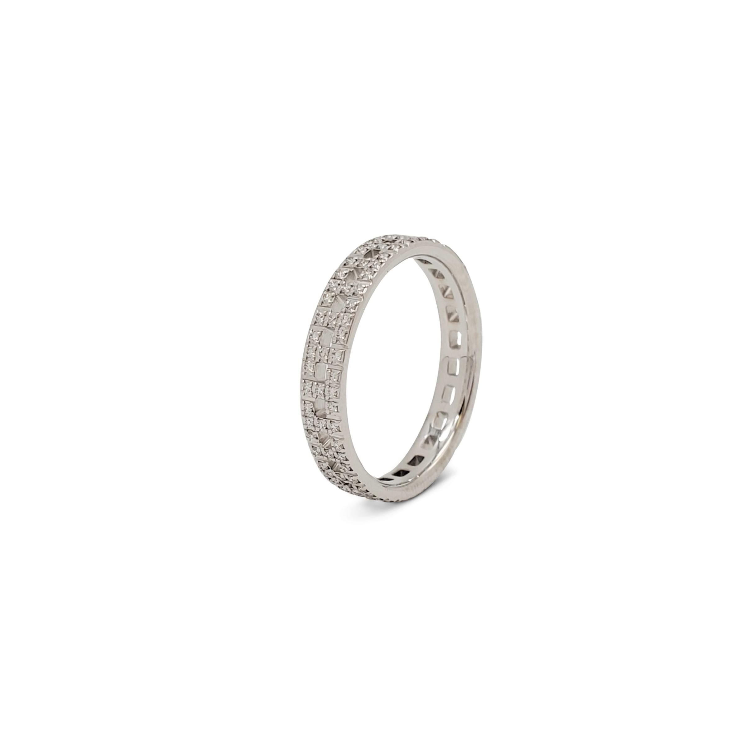 Authentic graphic Tiffany & Co. 'T True Narrow' band ring crafted in 18 karat white gold comprised of alternating links featuring the letter T traced in striking pavé diamonds weighing an estimated 0.23 carats total weight (E-F, VS). Signed Tiffany