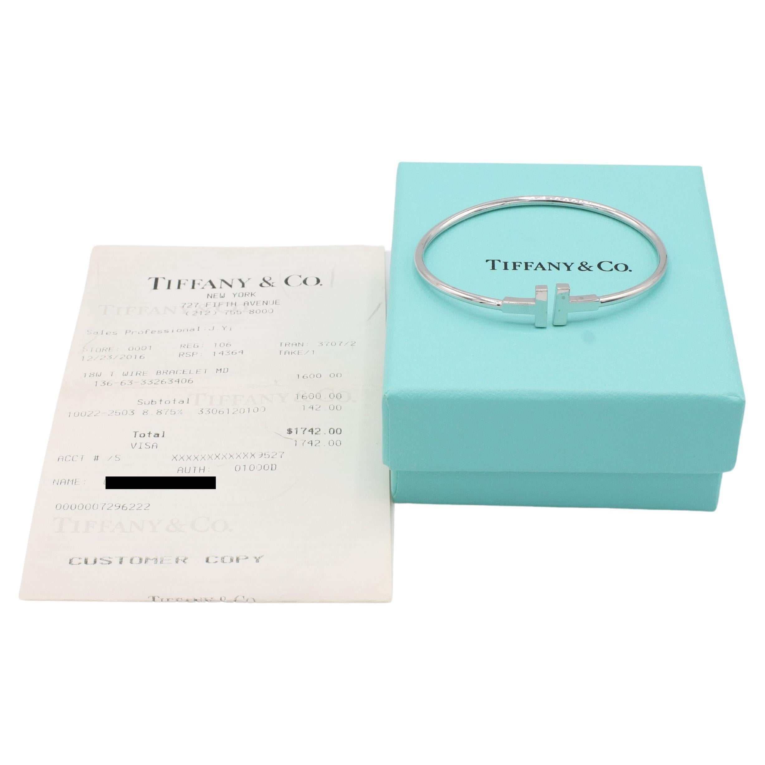 Tiffany & Co. T Wire 18 Karat White Gold Bangle Bracelet 
Metal: 18k white gold
Weight: 7.82 grams
Size: Medium, fits up to a 6.25 inch wrist
Width: 2.5mm
Diameter: 2.25 inches
Retail: $2,800 USD
Note: Original receipt & box
