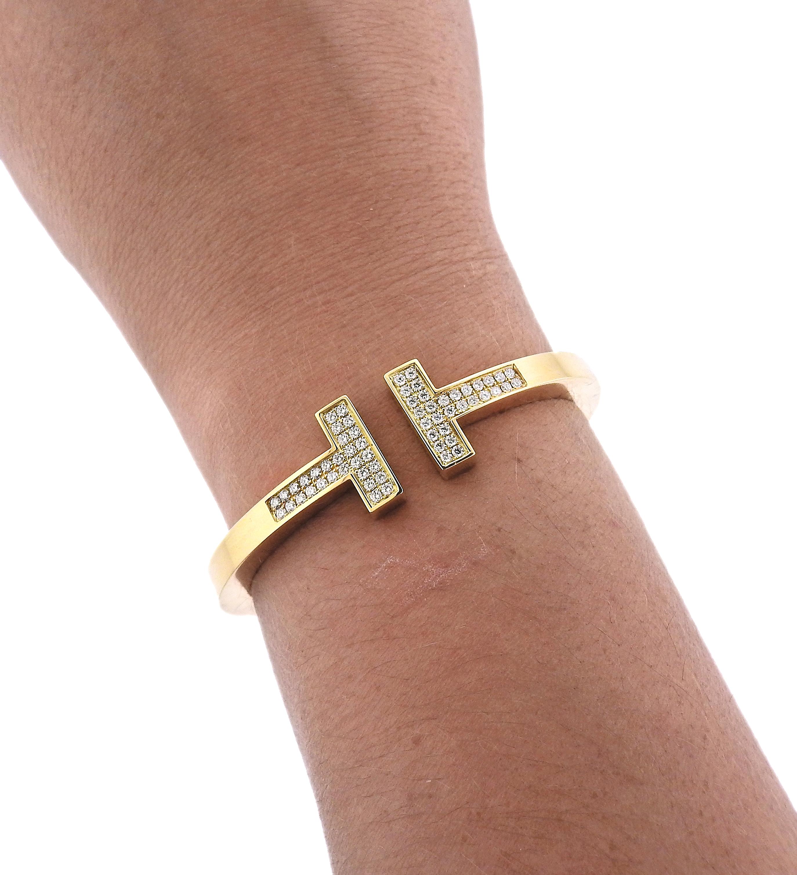 Iconic T bracelet by Tiffany & Co, in 18k yellow gold, with approx. 0.74ctw in G/VS diamonds. Retail $13500. Comes with T & Co box. Bracelet is Tiffany & Co size small. Will fit up to a 6