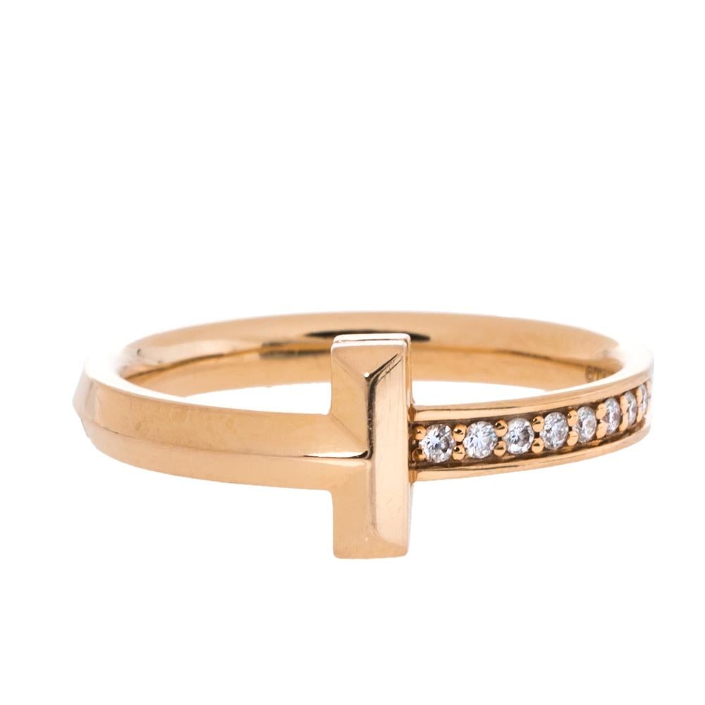 The T1 line Tiffany & Co. represents individual strength and power through strong lines and precious materials. This ring in 18k rose gold has a signature T and a stream of diamonds that illuminate one side. The ring shines with a timeless