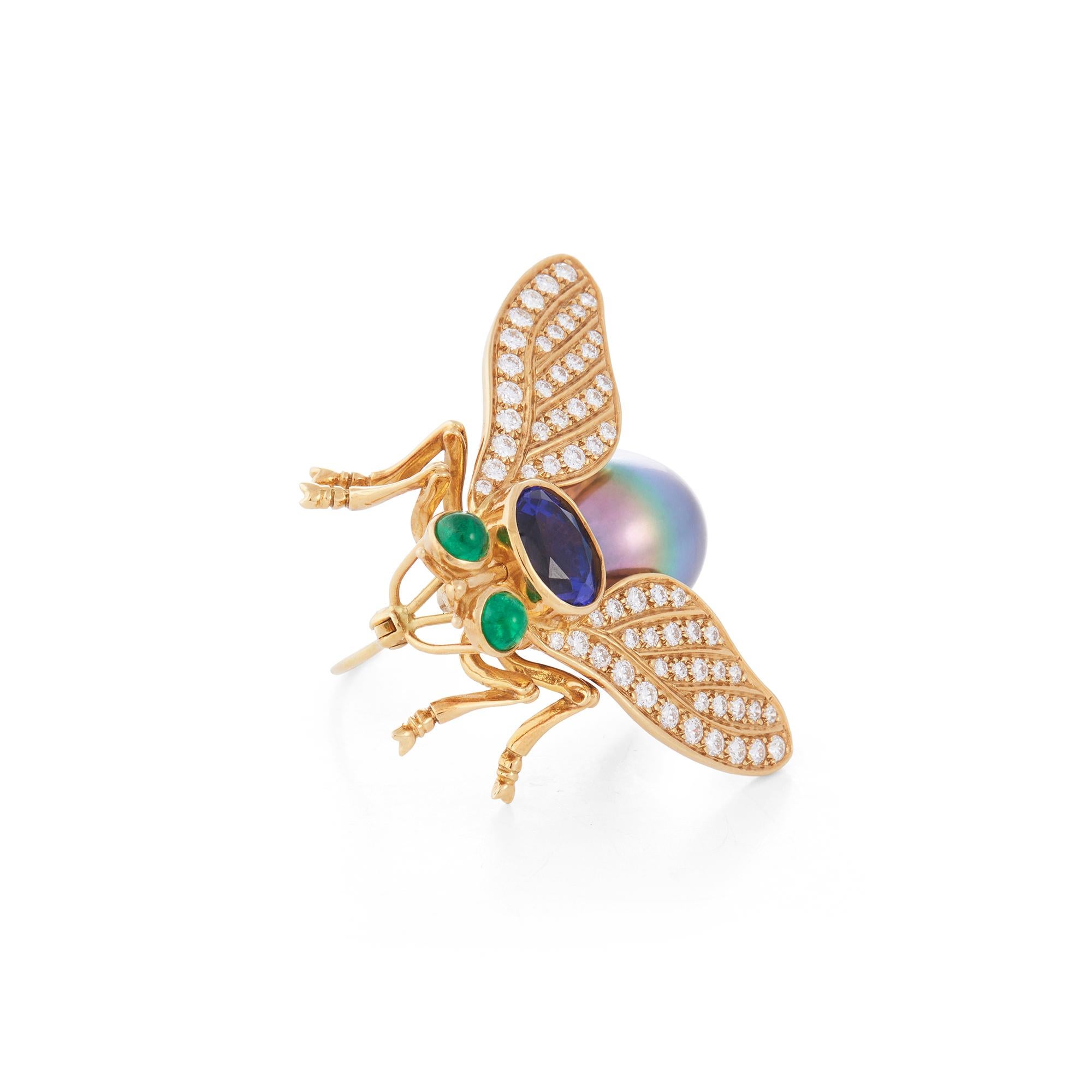 Authentic Tiffany & Co. brooch crafted in 18 karat yellow gold and designed as a fly, the body set with a Tahitian pearl and an oval cut tanzanite, the wings pave-set with 62 round brilliant cut diamonds weighing an estimated 0.75 carats, and the