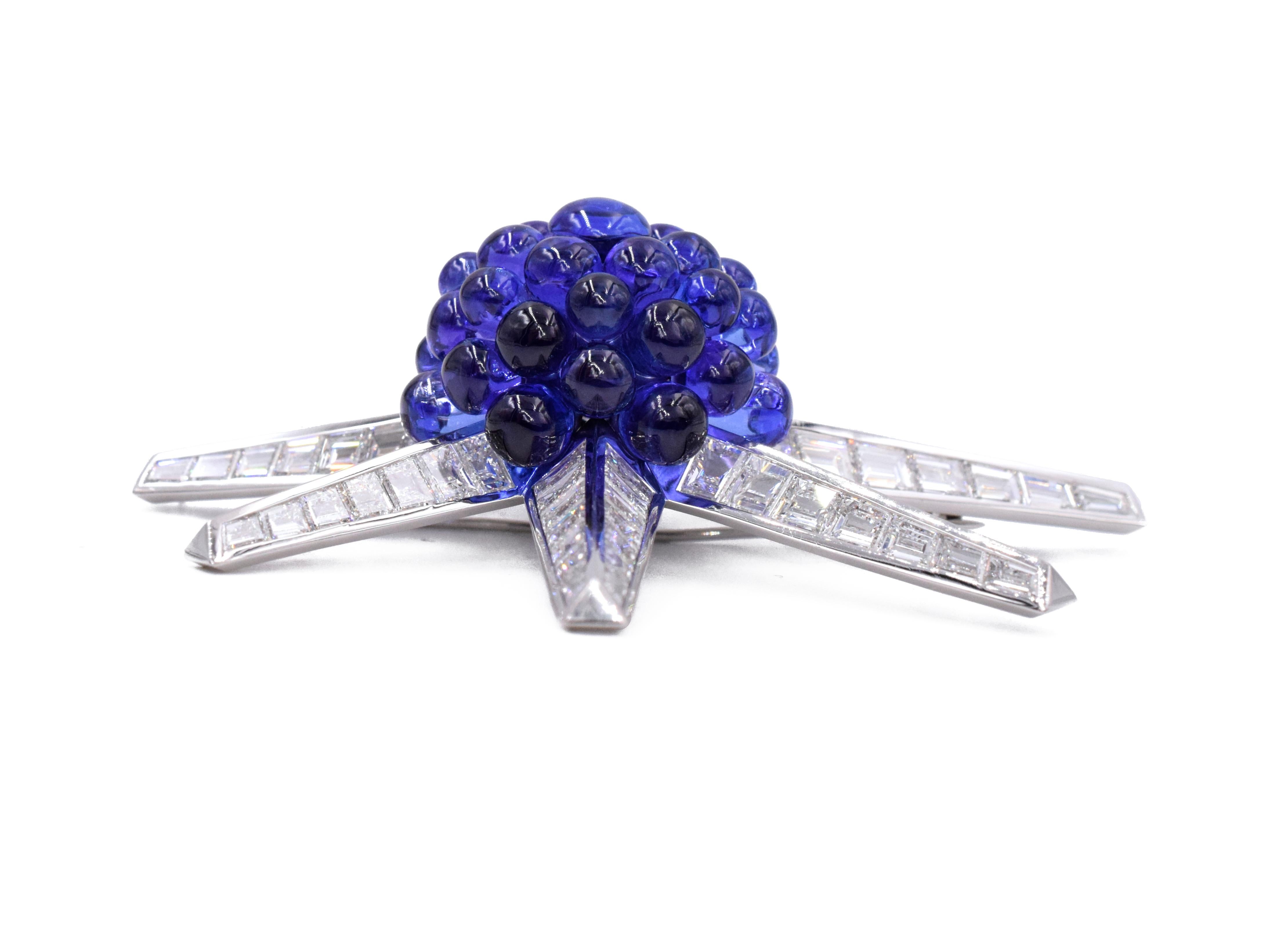Tiffany & Co. Tanzanite and Diamond Brooch
Designed as a star, the center set with a cluster of tanzanite cabochons extending channel-set tapered baguette-cut diamond rays, 2 3/4 ins., mounted in platinum.
The brooch has approximately 21 carats fine