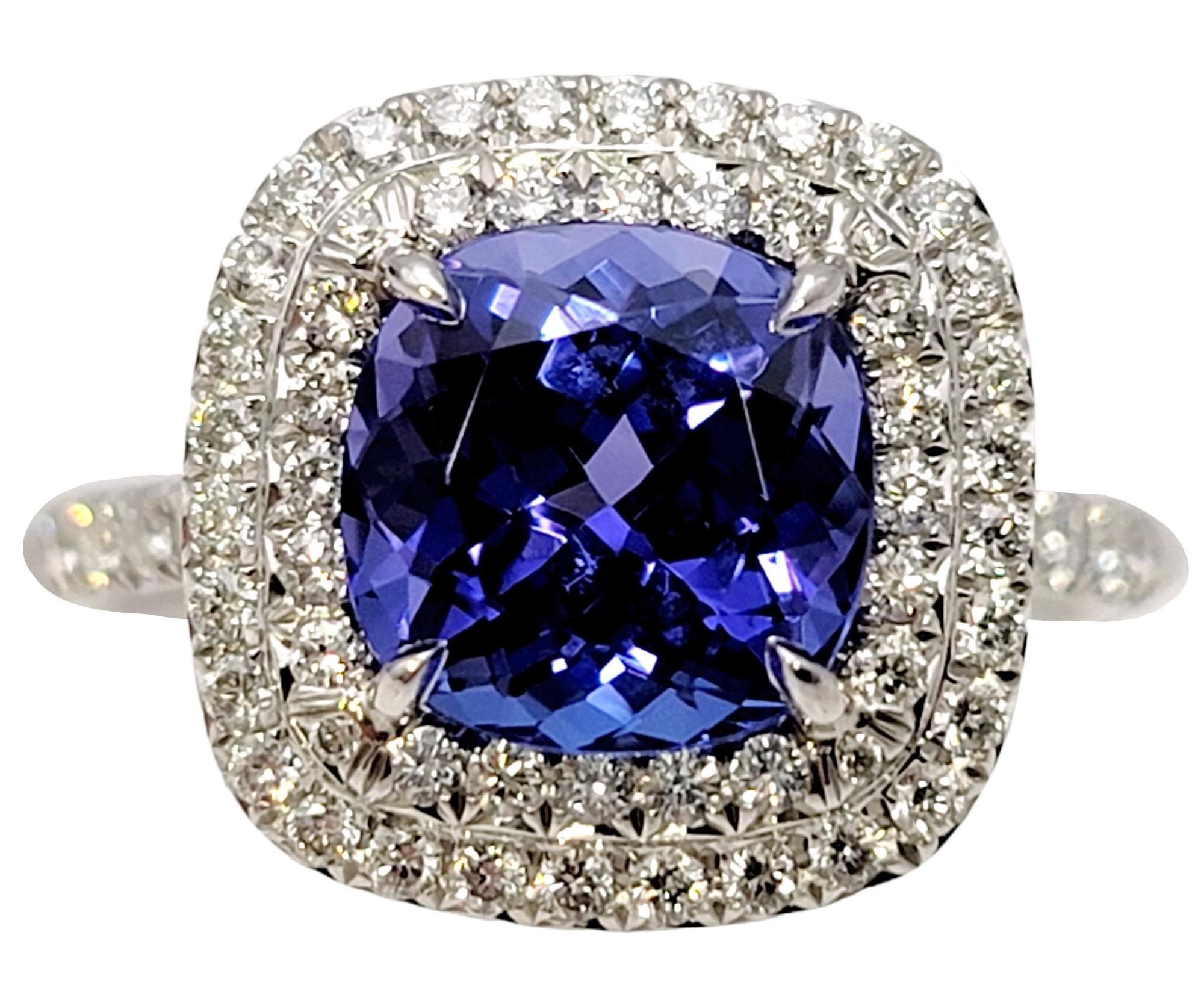 Ring size: 6.5

Breathtaking double halo tanzanite and diamond band ring from renowned jeweler, Tiffany & Co.. The scintillating Soleste ring will absolutely radiate on her finger. The striking bluish-violet cushion cut center stone is paired with a