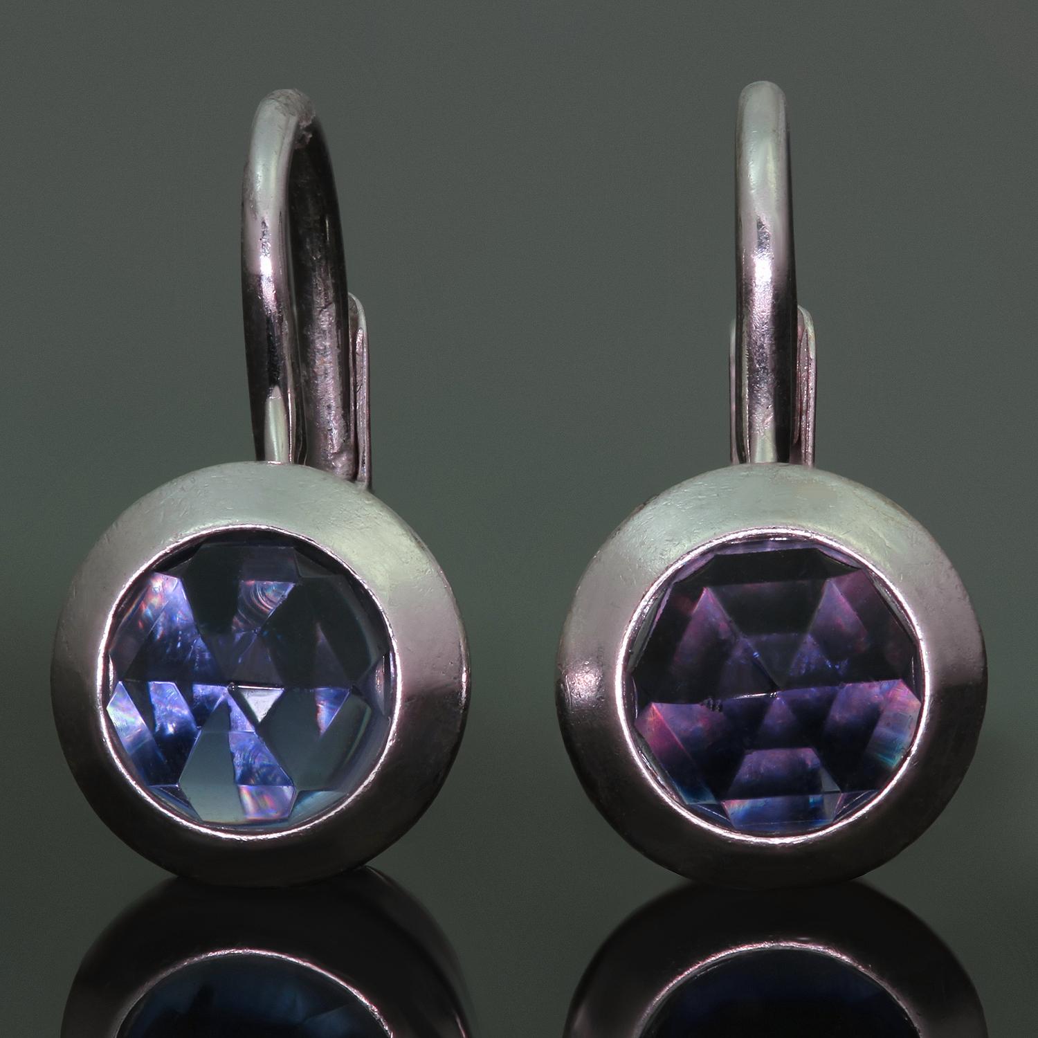 This exquisite Tiffany & Co. dangling earrings are crafted in 18k white gold and set with faceted round tanzanite stones. France circa 2000s. Measurements: 0.31