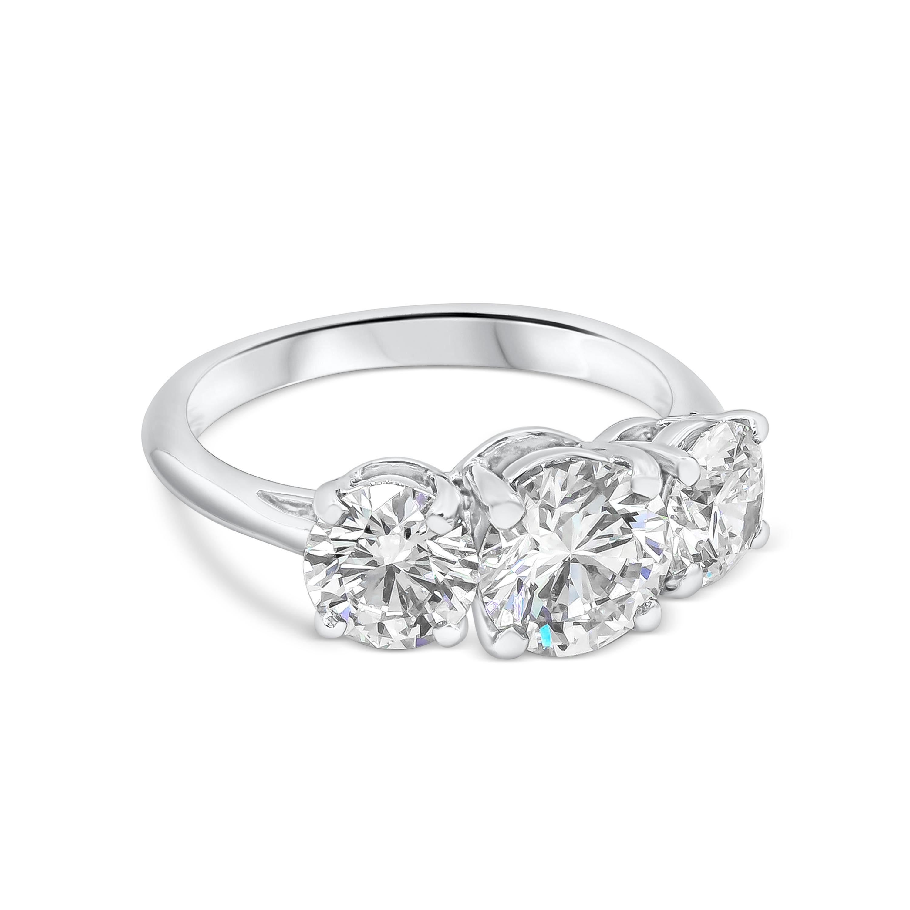 Classic three-stone engagement ring by Tiffany & Co. The center diamond is 1.22ct H, VS1. Flanked on either side by round diamonds 0.71ct H, VS1 and 0.71ct J, VVS2. All three diamonds are certified by GIA. The ring set in Platinum 950. Signed and
