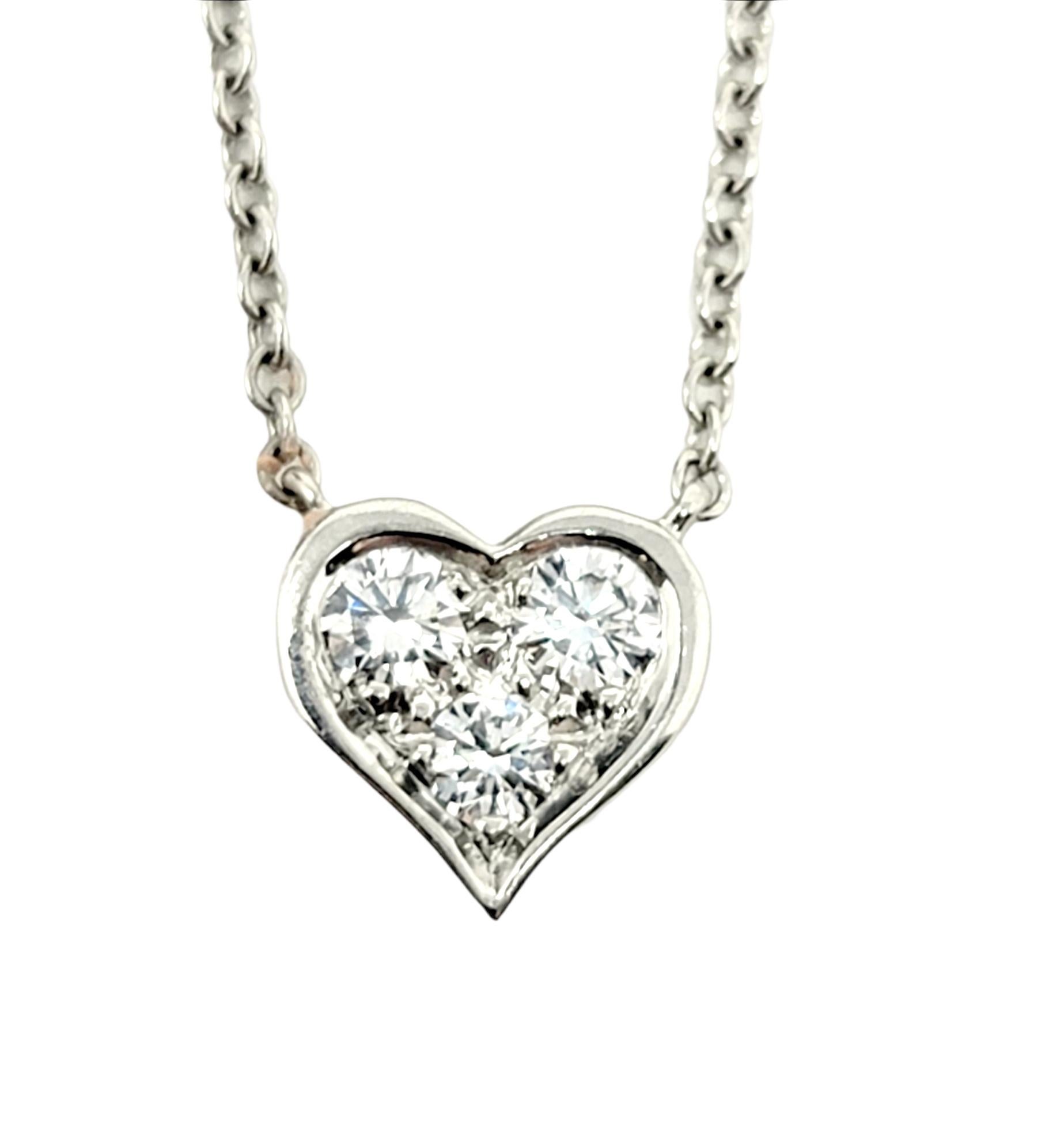 The diamond heart pendant necklace from Tiffany & Co. is stunningly simple, yet undeniably beautiful. Featuring a delicate platinum chain and an icy trio of natural round diamonds, this necklace goes with just about everything. It features 3 round