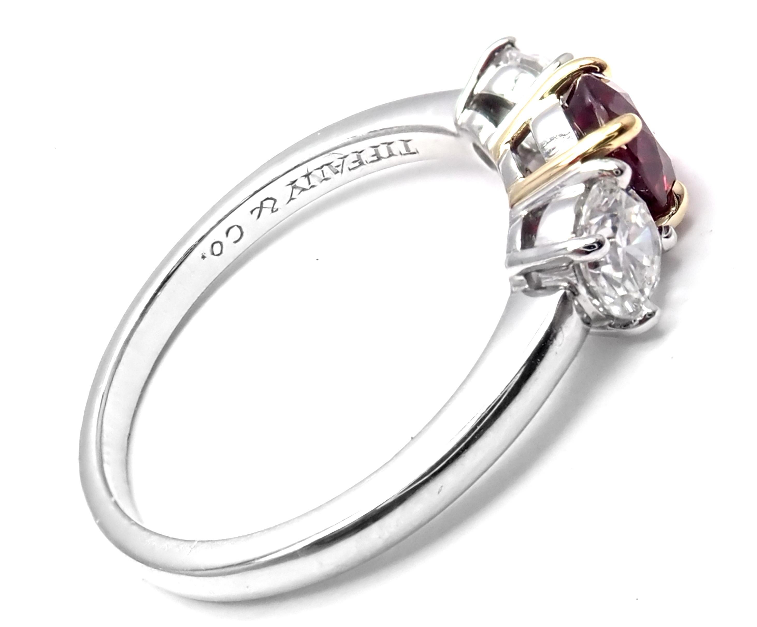 Platinum And 18k Yellow Gold Diamond And Ruby Three Stone Band Ring by Tiffany & Co. 
With 22 Round Brilliant Cut Diamonds VS1 clarity, G color, Total weight Approx .60ctw
1 Round Ruby total weight approx.  0.60ct
Details:
Ring Size: 6
Width: