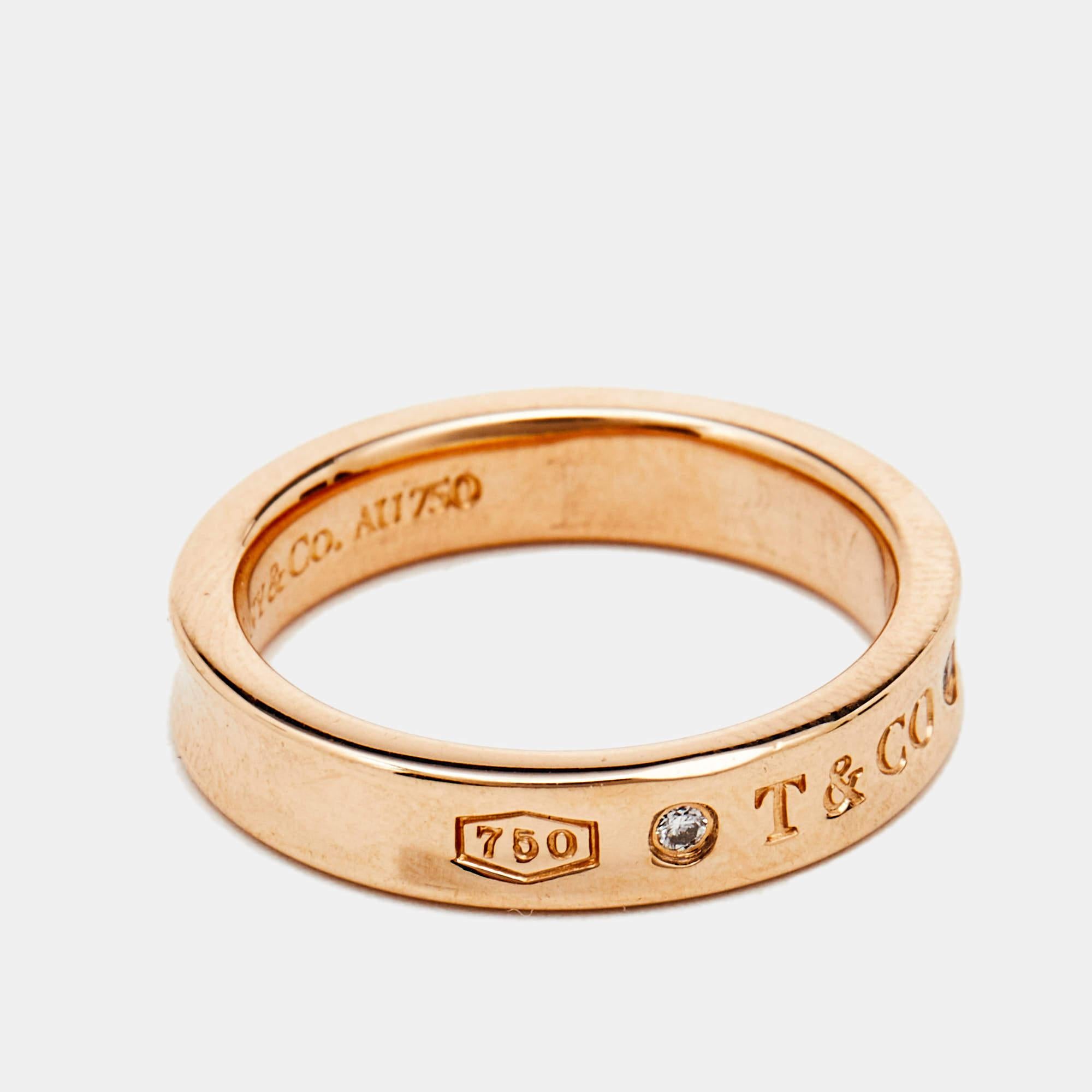 We'd love this Tiffany & Co. piece to complement our everyday style. The ring is made of 18k rose gold, embellished with diamonds, and inscribed with logo details and 1837 — the year the brand was founded. It has a smooth finish and a comfortable