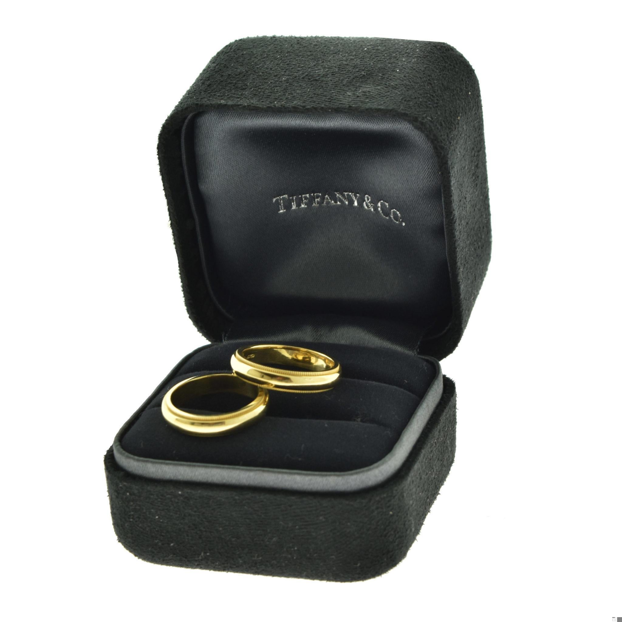 Designer: Tiffany & Co.

Style: Double Milgrain Band Rings

Metal: Yellow Gold

Metal Purity: 18k

Ring 1 Size (His): 7.25 - 7.5

Ring 1 Width (His): 4.15 mm

Ring 1 Weight (His): 6.2

Ring 2 Size (Hers): 6

Ring 1 Width (Hers): 4.15 mm

Ring 1