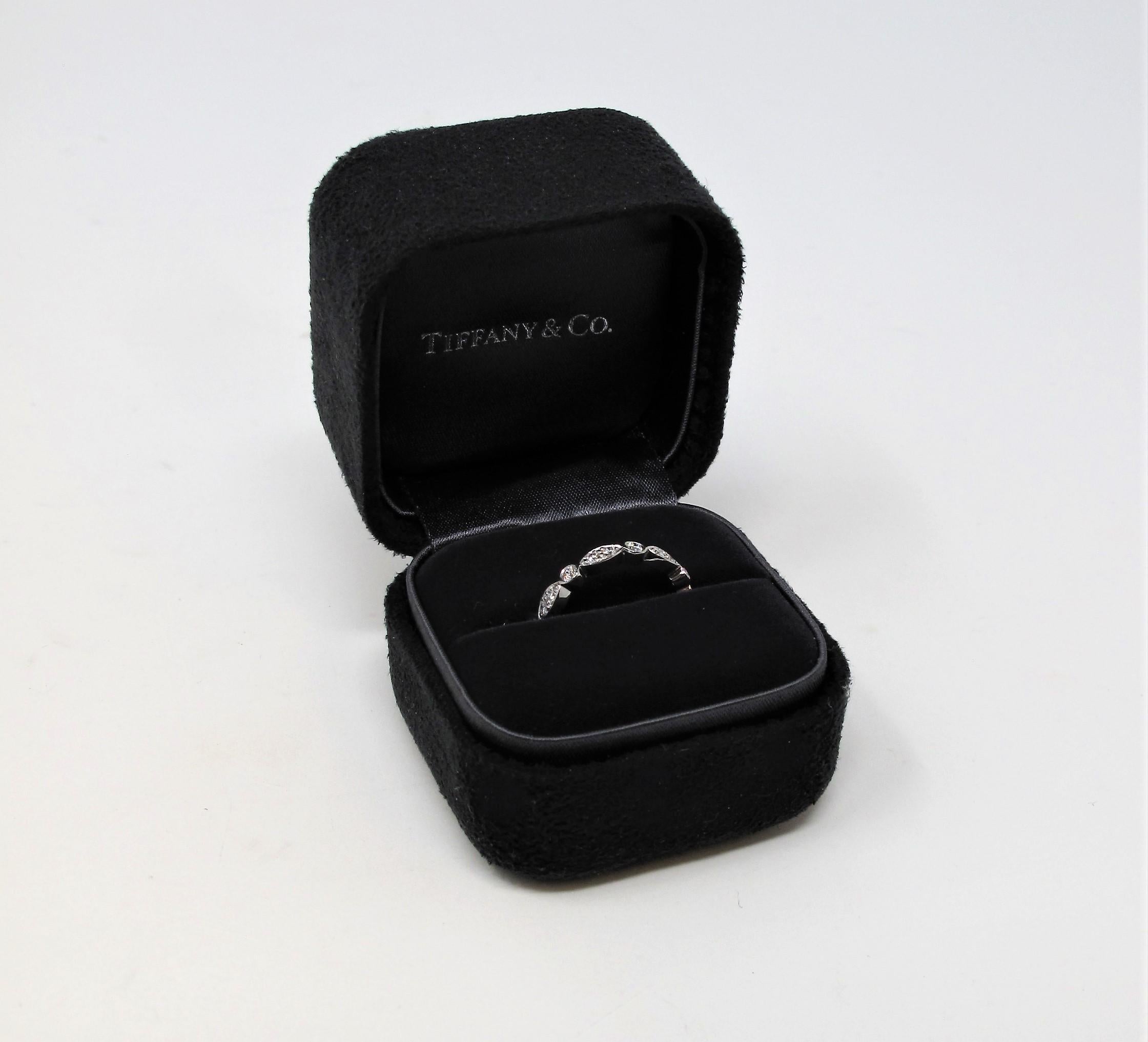 Exquisite Tiffany Jazz diamond and platinum band ring from renowned jeweler, Tiffany & Co.. This incredible ring has a vintage style charm with a modern, feminine twist.  It would be perfect paired with an engagement ring, or simply worn on its own.