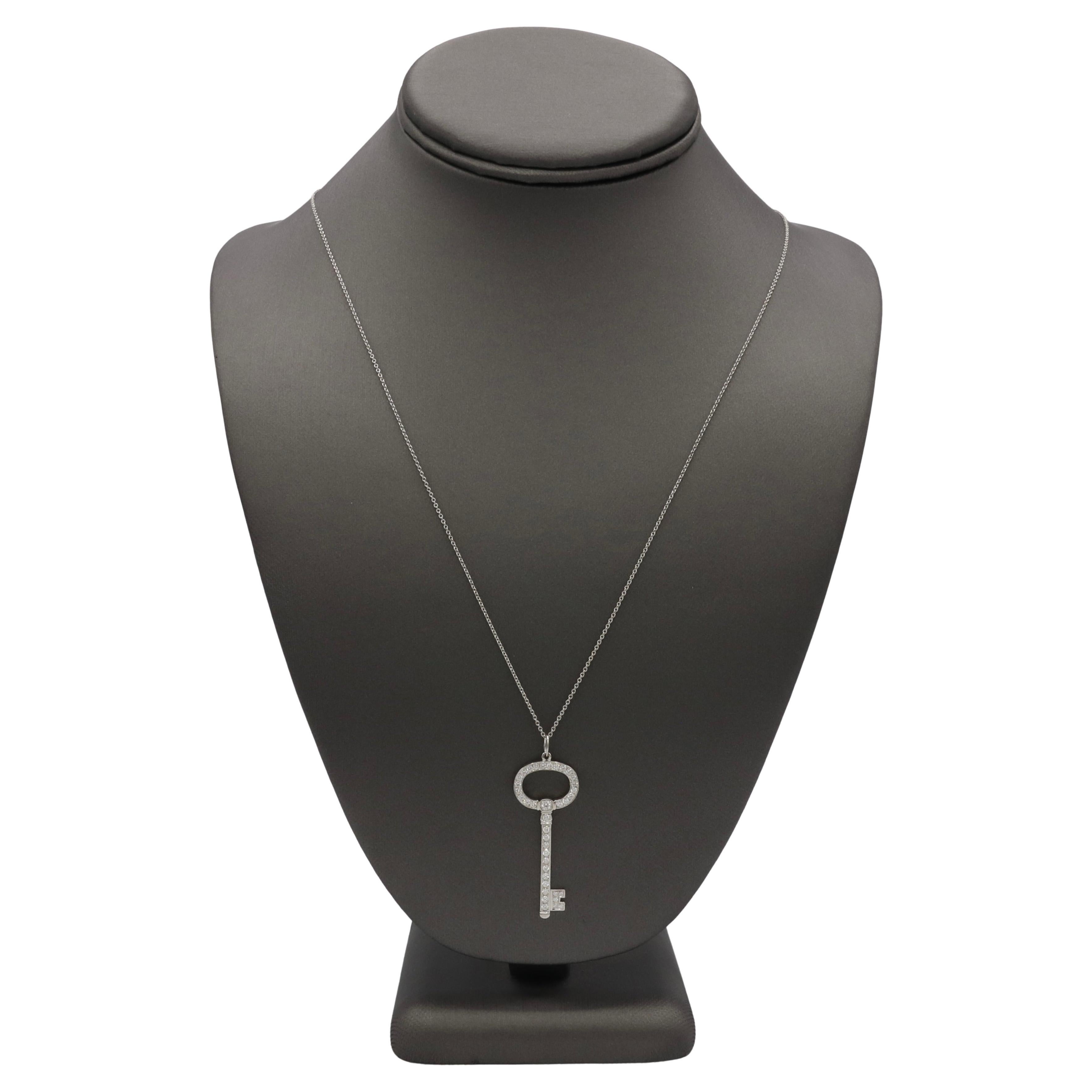 Tiffany & Co. Tiffany Kets Platinum Natural Diamond Pendant Drop Necklace 
Metal: Platinum
Weight: 7.90 grams
Diamonds: Approx. 0.75 CTW natural D-F VVS round diamonds
Key: 1.65 inch
Chain: 24 inch
Signed: ©Tiffany & Co. PT950

