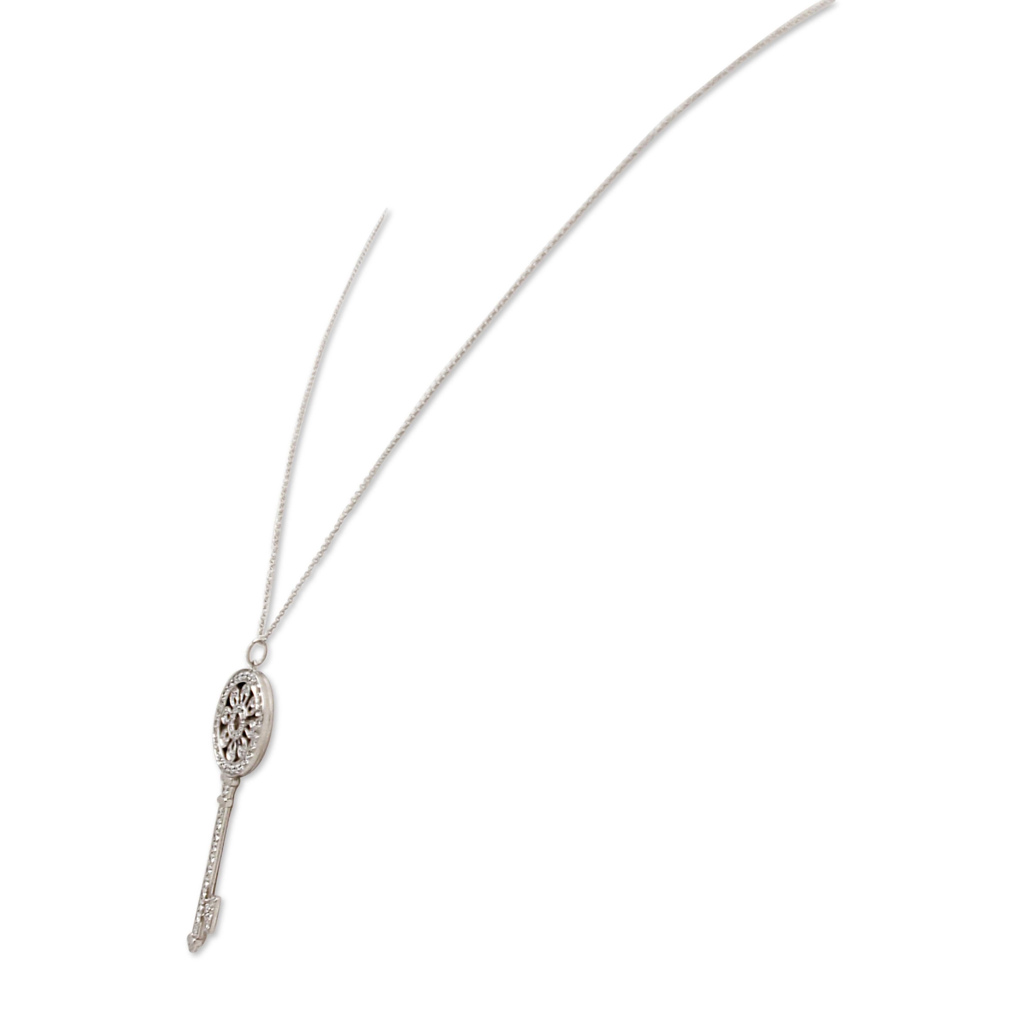 Authentic Tiffany & Co. Petal Key pendant crafted in platinum and set with approximately 1.14 carats of glittering round brilliant cut diamonds.  The pendant measures 2 1/4 inches and is situated on a delicate 20 inch chain.  Pendant and chain are