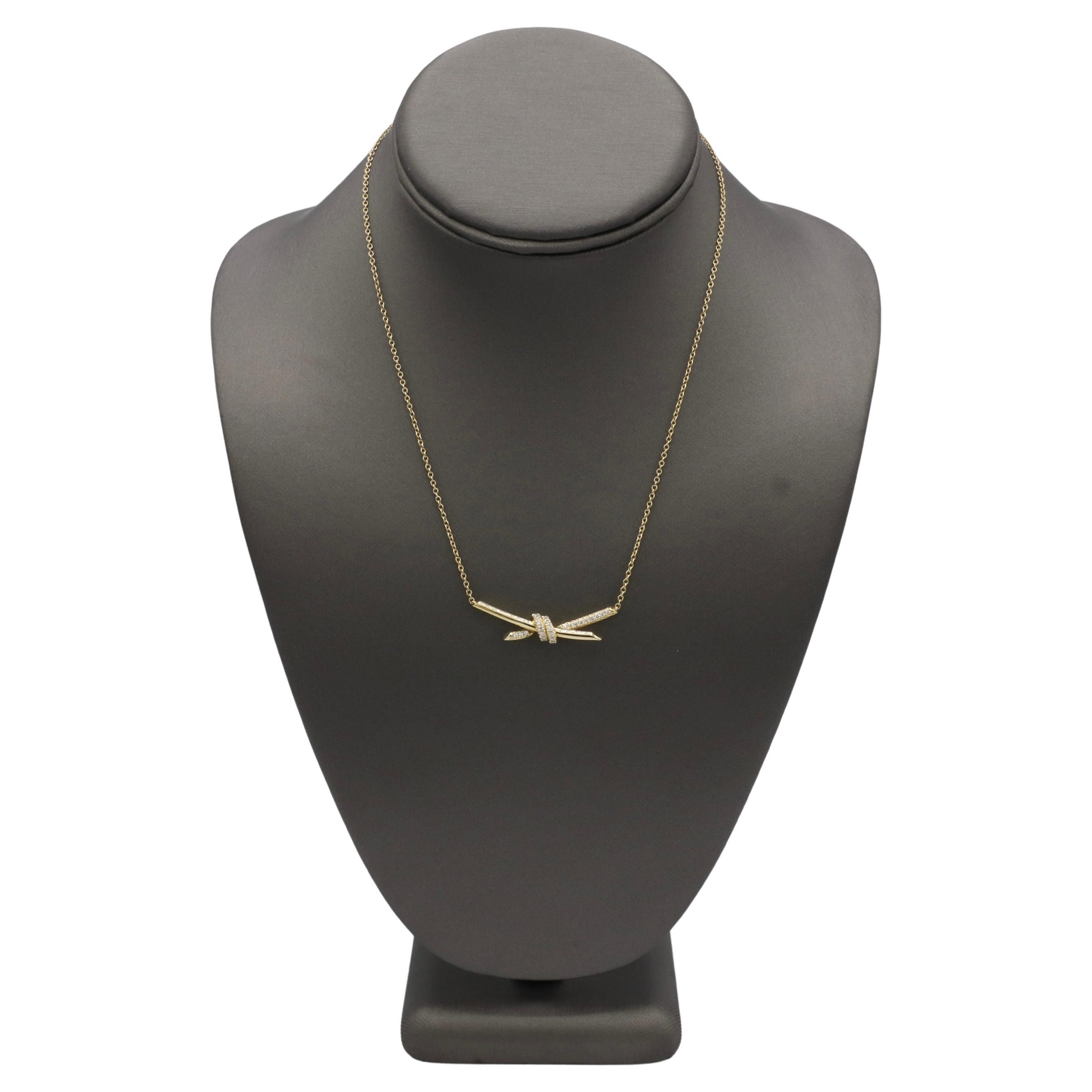 Tiffany & Co. Tiffany Knot 18 Karat Yellow Gold Natural Diamond Pendant Necklace
Metal: 18k yellow gold
Weight: 8.06 grams
Diamonds: 0.25 CTW natural round diamonds F-G VVS
Chain:  15-17 inches
Pendant: 39mm
Signed: ©T&Co. Au750 d0.25ct ©Tiffany &