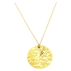 Tiffany & Co. Tiffany Notes Engraved 18k Yellow Gold Round Wave Pendant Necklace