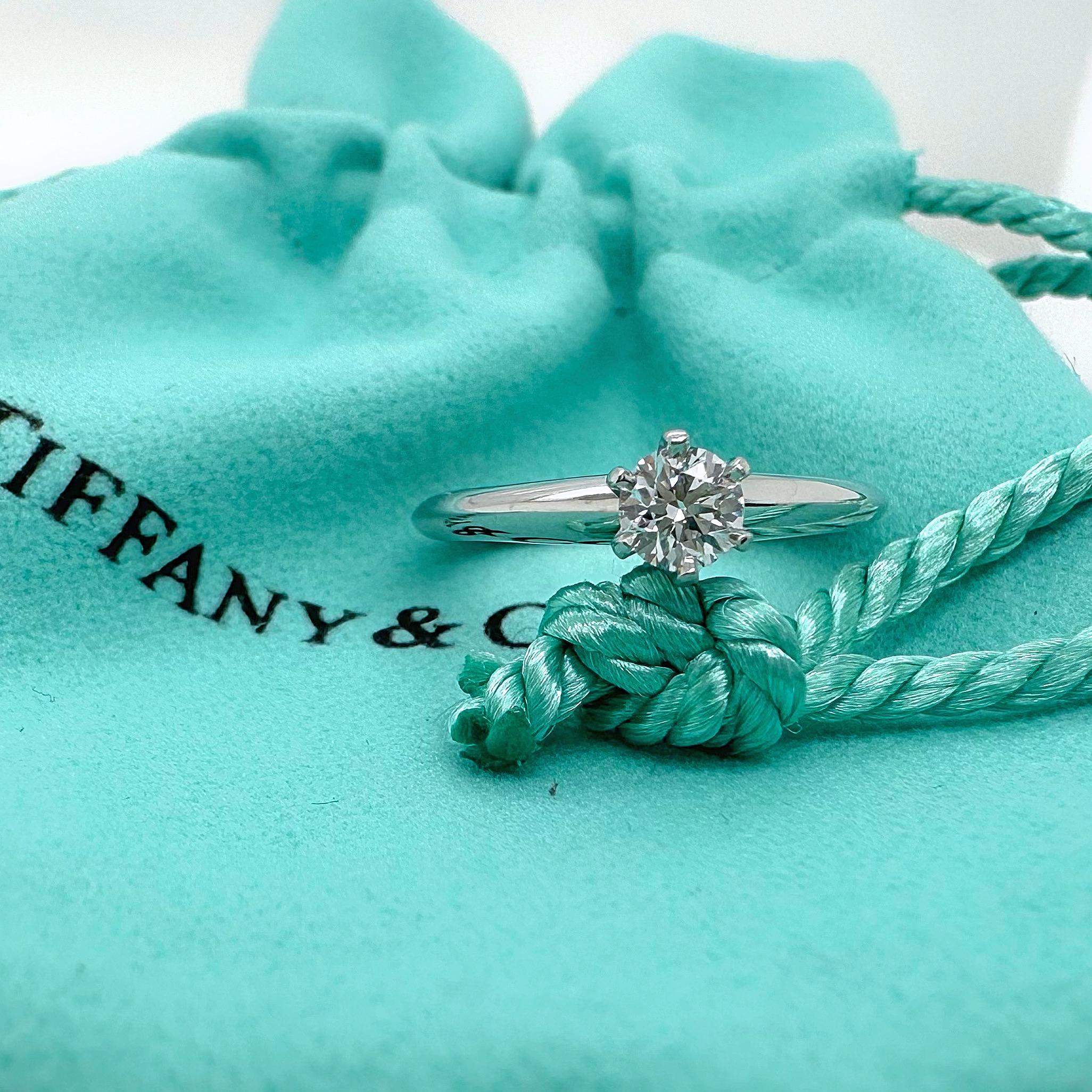 Tiffany & Co. Tiffany Setting Round Diamond Engagement Ring
Style:  Solitaire
Ref. number:  29062811
Metal:  Platinum
Size:  4.5 sizable
Measurements:  2 mm
Main Diamond:  0.25 cts
Color & Clarity:  E, VS1
Hallmark:  ©TIFFANY&CO. PT950 29062811
