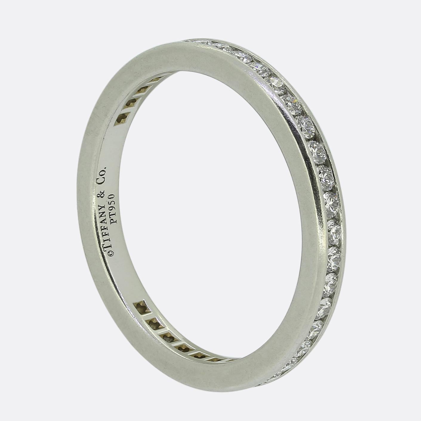 Here we a classically styled diamond eternity ring from the world renowned jewellery designer, Tiffany & Co. This contemporary piece features 42 round brilliant cut diamonds; all of which have been channel set in a single line formation to wrap