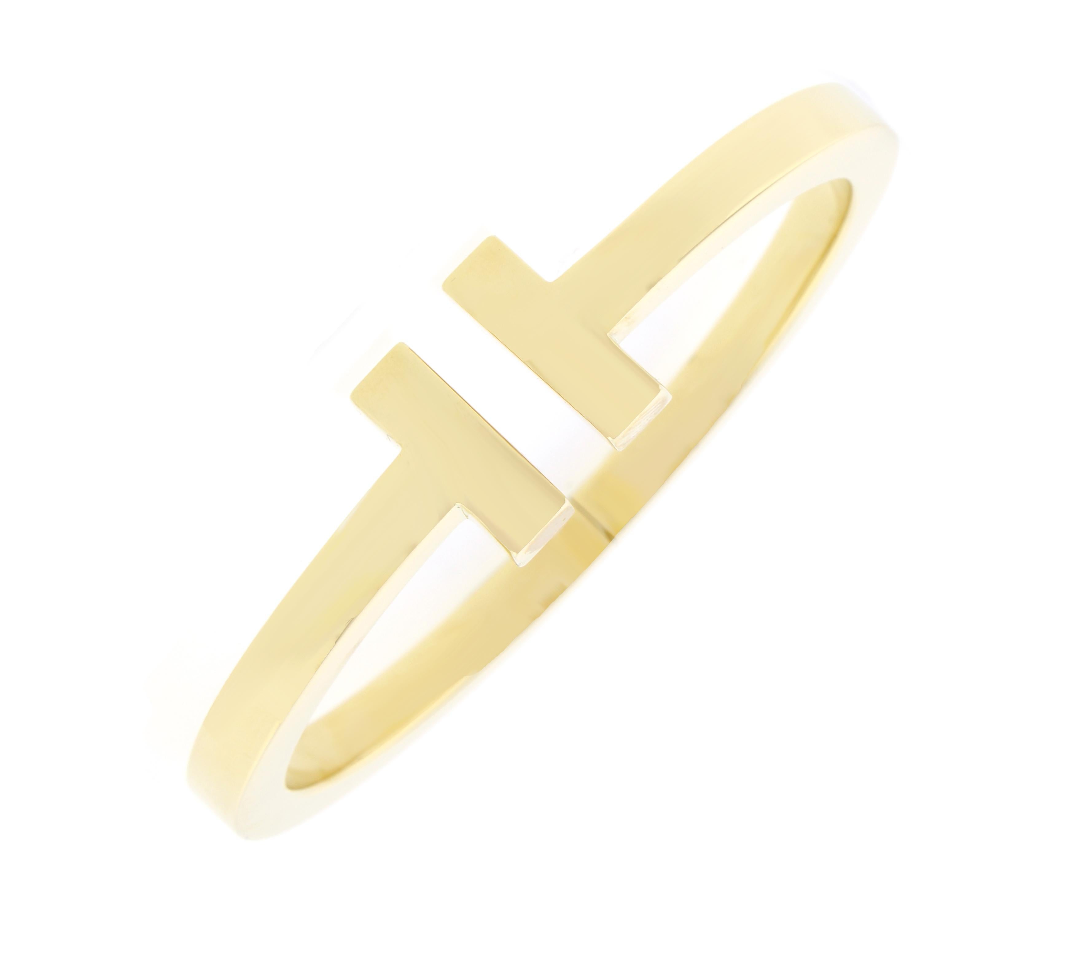 From Tiffany & Co. thier Tiffany Square T bangle bracelet. With graphic angles and clean lines the Tiffany T bracelet is sleek and sophistication.

18 karat gold
Size medium
Fits wrists up to 6.25