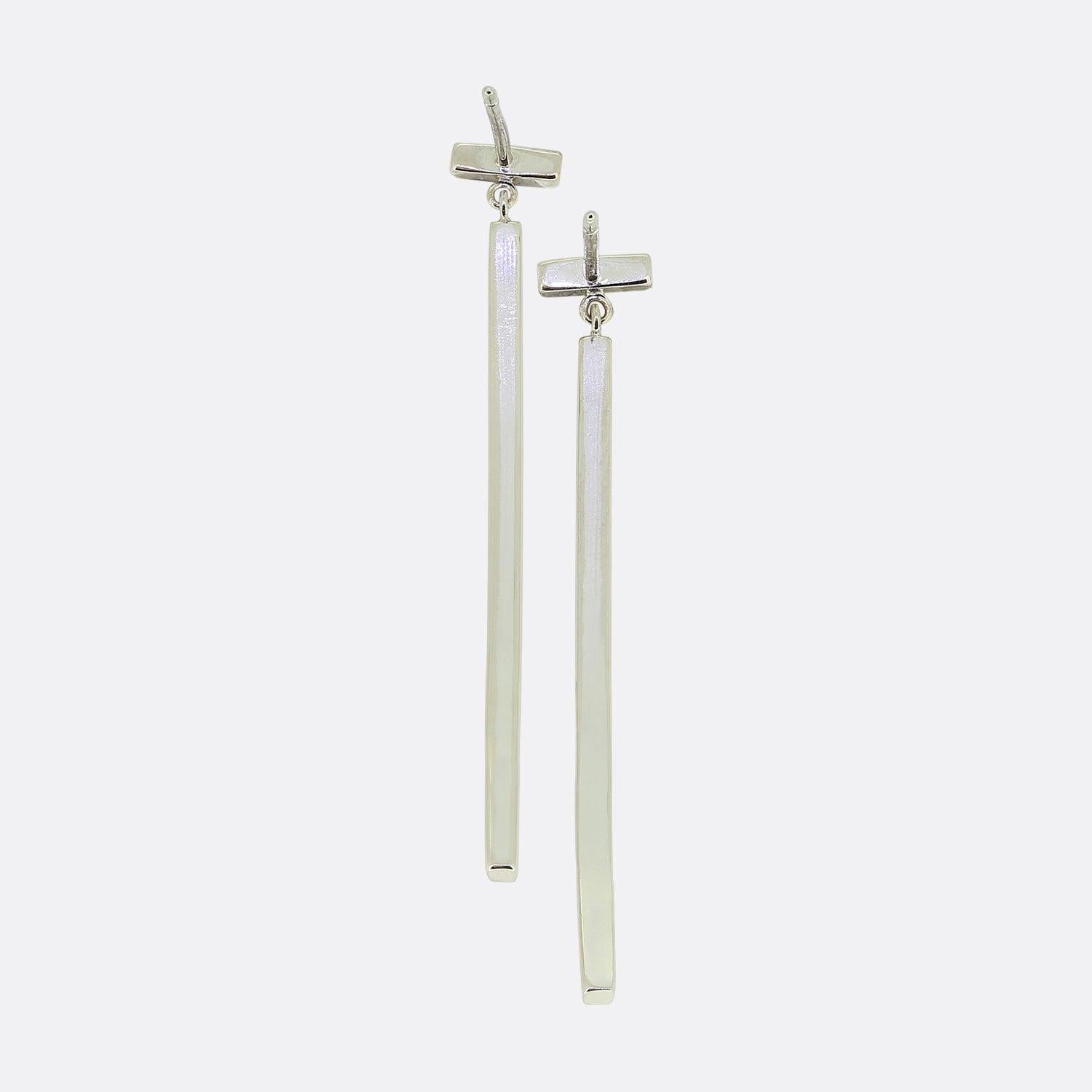 Here we have a stunning pair of dangle diamond earrings from the world renowned jewellery designer, Tiffany & Co. 

Accented with diamonds, these bold bars are a modern take on the drop earring. As multifaceted as it is iconic, the Tiffany T
