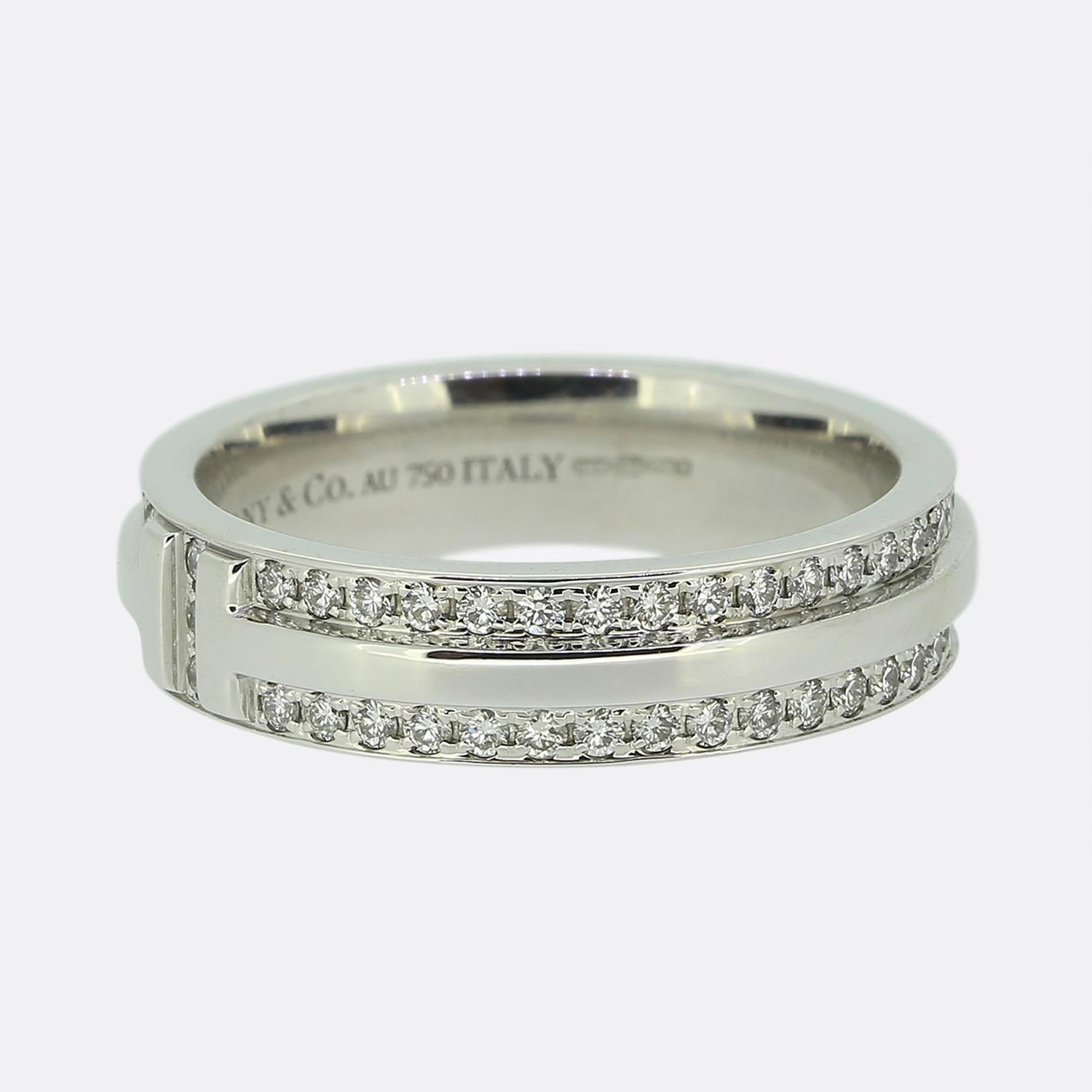 Here we have a fabulously crafted diamond band ring from the world renowned jewellery designer Tiffany & Co. This ring forms part of their T True collection and is the wider model featuring the iconic T motif around the entire band with two rows of