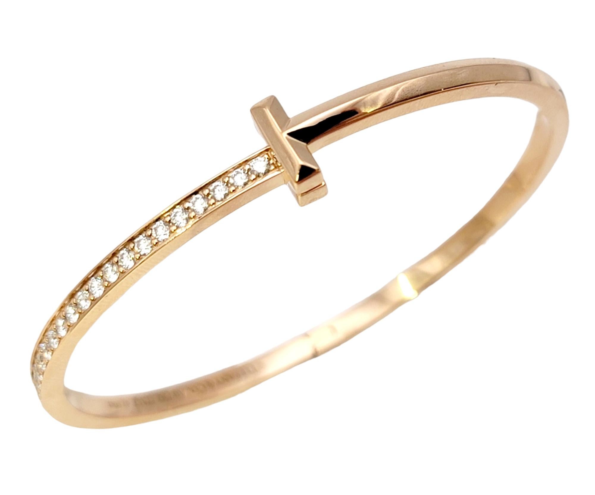 Stunning and sophisticated Tiffany & Co. diamond bangle bracelet from the stylish Tiffany T collection. Crafted with meticulous attention to detail, this luxurious piece exudes timeless beauty and grandeur.

Featuring lustrous rose gold, this