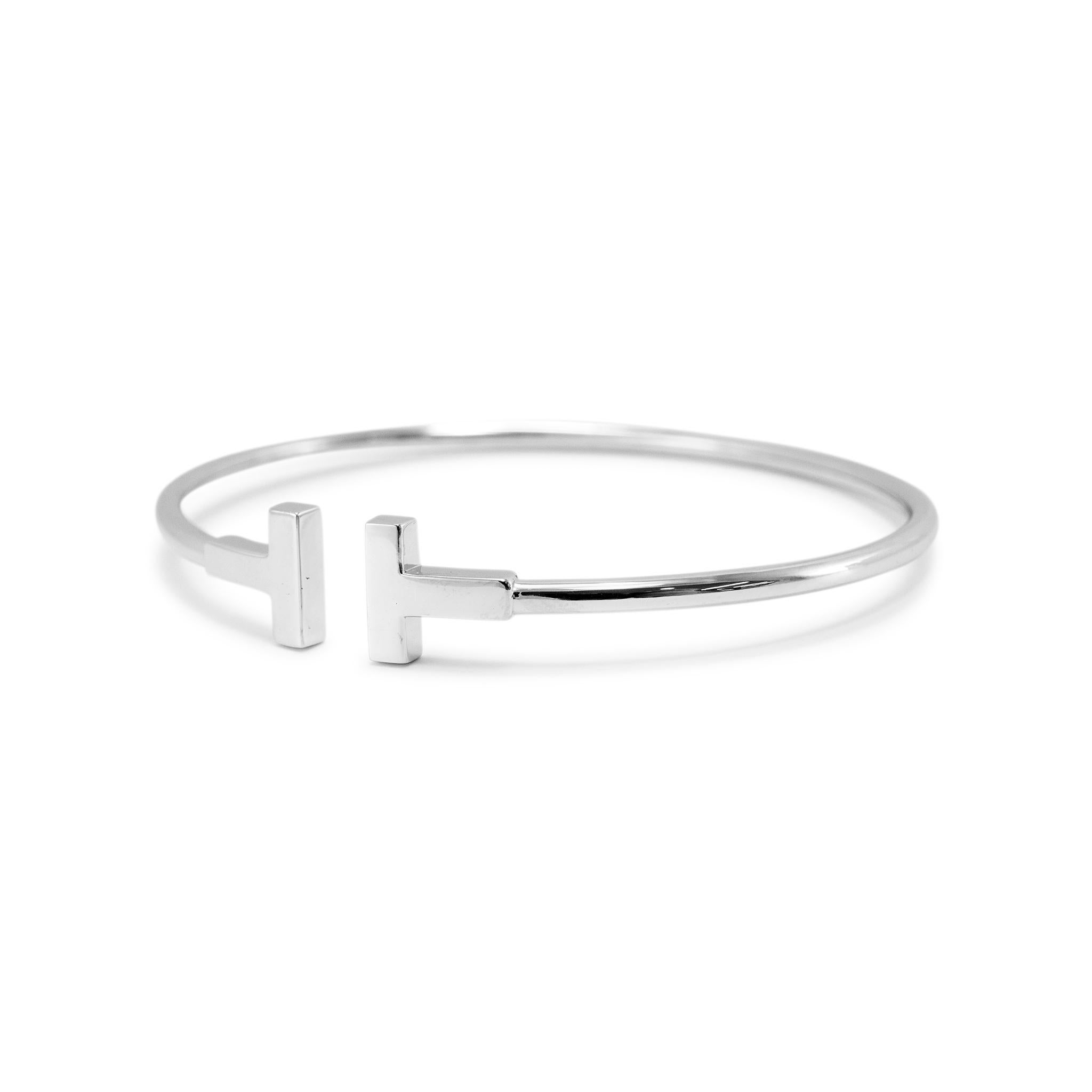 Brand: Tiffany & Co.

Gender: Ladies

Metal Type: 18K White Gold

Length: 6.50 inches

Width: 9.54 mm tapering to 2.40 mm

Weight: 8.57 grams

One ladies TIFFANY &Co. Rhodium-plated 18K white gold bangle cuff bracelet. Engraved with 