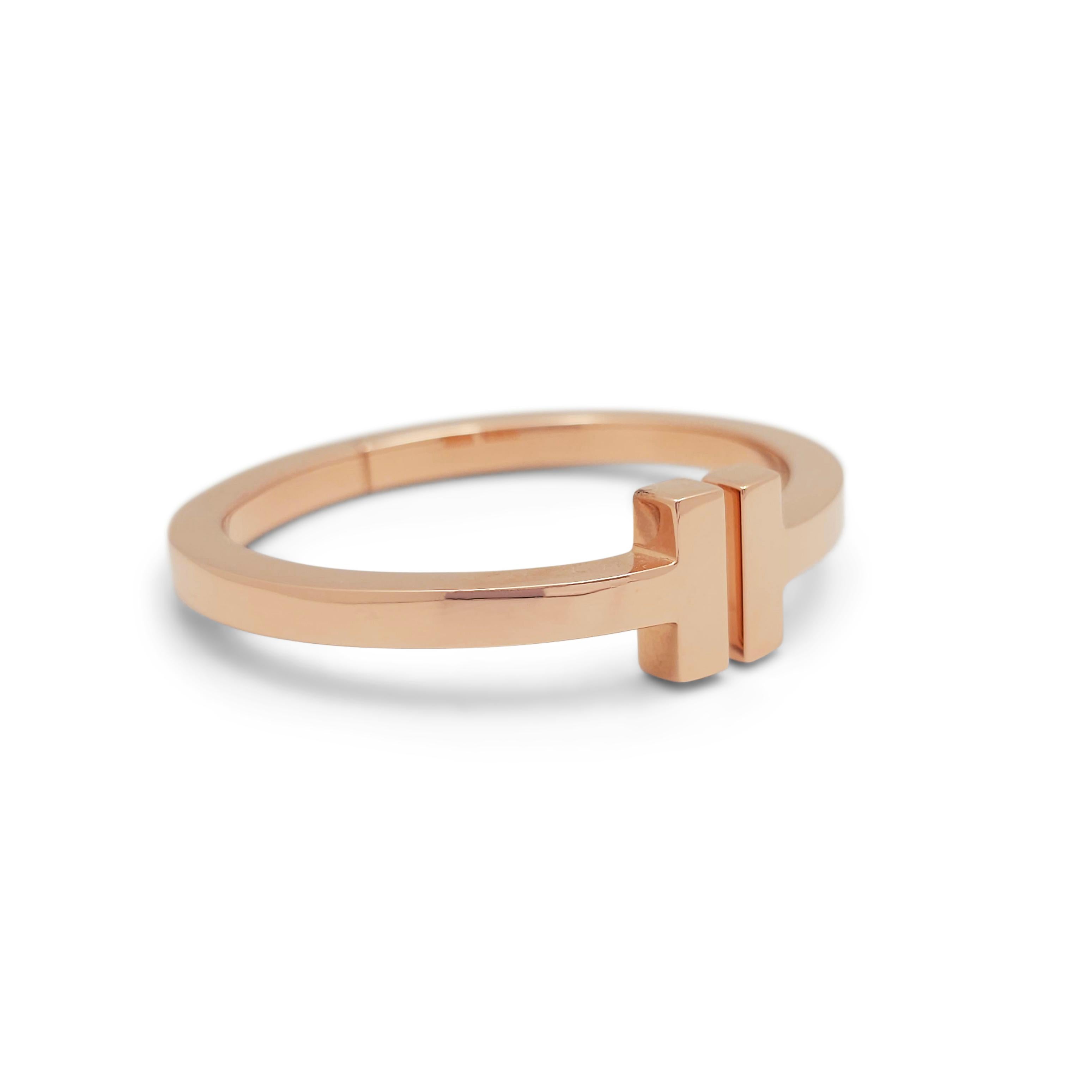 Authentic Tiffany T square bracelet crafted in 18 karat rose gold.  Each end of the split bangle is finished with the TIffany T motif.  Size extra small, will fit up to a 5 1/4 inch wrist.  Signed Tiffany & Co., Au 750, Italy.  Bracelet is presented