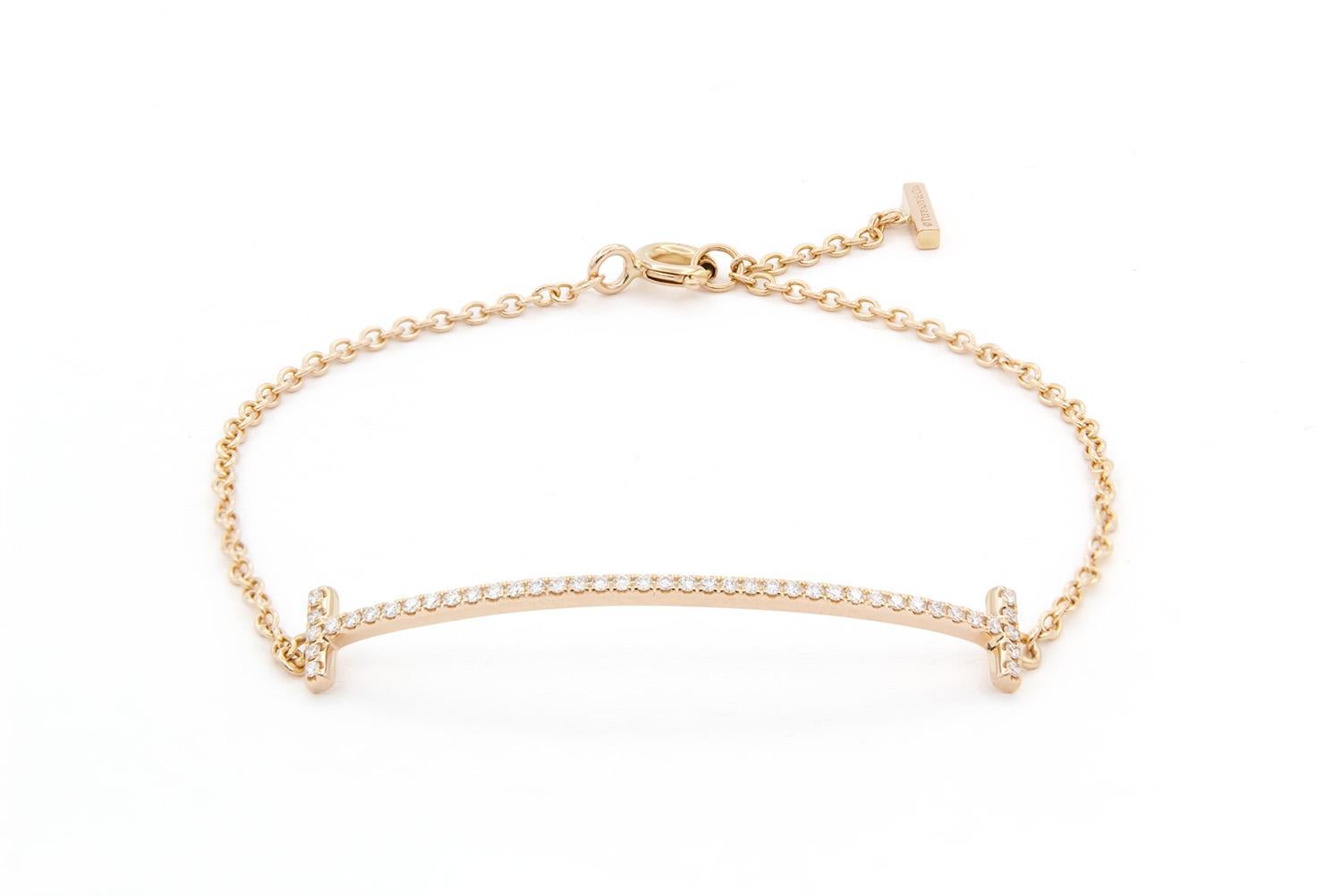 We are pleased to offer this Tiffany & Co Tiffany T Smile Bracelet. In classic Tiffany style this bracelet is finely crafted from 18k rose gold & diamonds. Streamlined and modern, this bracelet shines with sophistication and bold simplicity. Strong