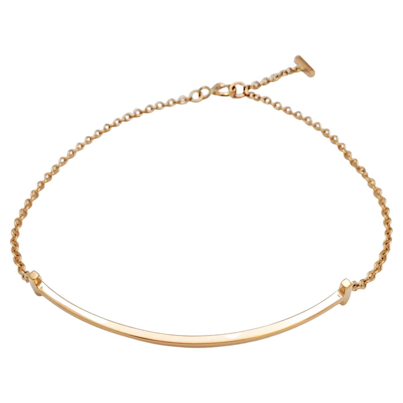 Authentic Tiffany & Co. Smile bracelet from the Tiffany collection crafted in 18 karat rose gold.  The smile motif sits at the center of a delicate chain.  Size large, will fit up to a 6.75 inch wrist.  Signed Tiffany & Co., Au 750, Italy.  Bracelet